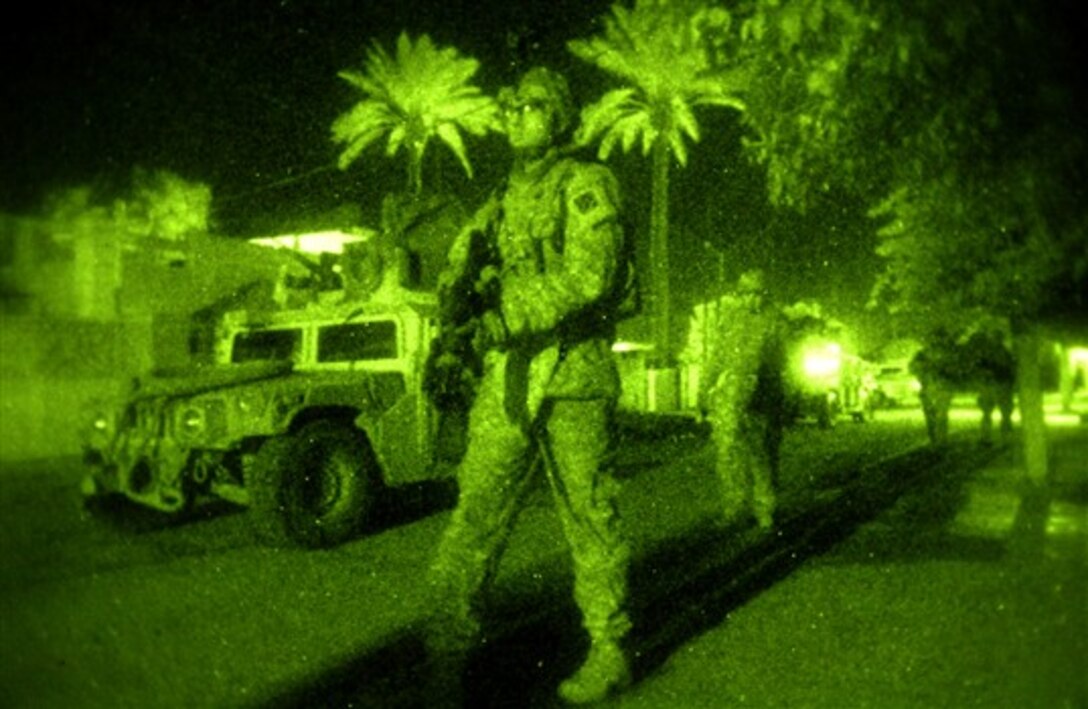 U.S. Army soldiers assigned to 2nd Combined Arms Battalion, 69th Armor Regiment, conduct a night patrol to discourage enemy activity in Baghdad, Jan. 15, 2008.  
