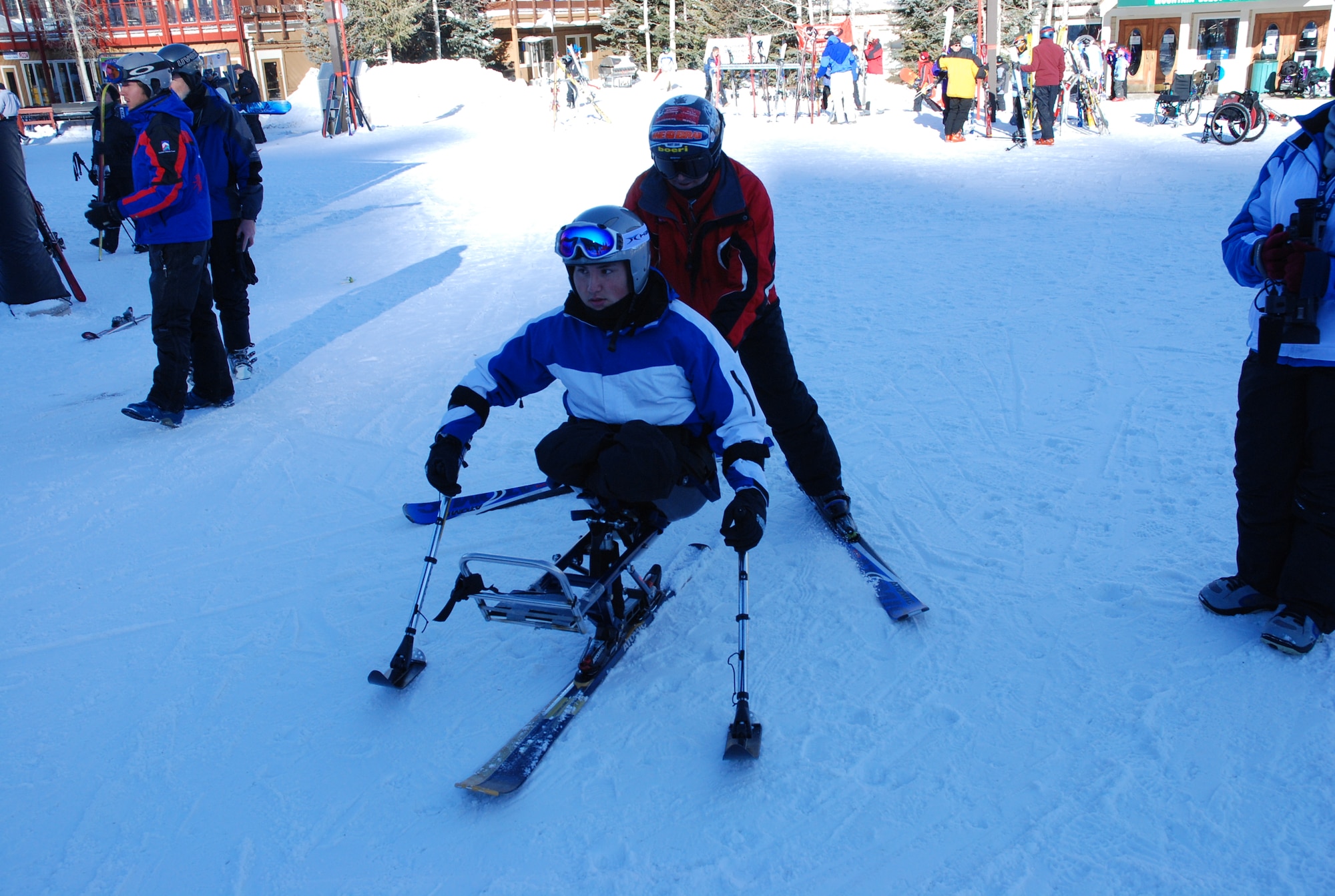 Airman 1st Class Kevin Krogh gets guided to the gondola for a ride up the mountain in Keystone, Colo., Jan. 26. Airman Krogh, who was injured during an automobile accident, is an F-22 Raptor weapons loaders assigned to Langley AFB, Va., is taking advantage of free ski lessons through Adaptive Adventures, Inc. Airman Krogh was one of several  disabled servicemembers who took advantage of the company's free ski lessons offered during the annual SnoFest military community event in Keystone, Colo. (U.S. Air Force photo/Senior Airman Stephen Collier)