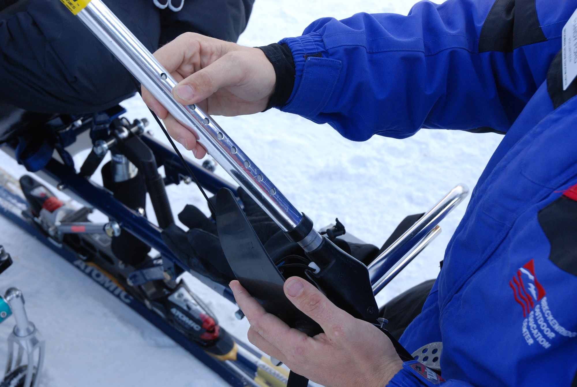 An Adaptive Adventures, Inc. instructor measures ski poles for Airman 1st Class Kevin Krogh Jan. 26. Airman Krogh, who was injured during an automobile accident, is an F-22 Raptor weapons loaders assigned to Langley AFB, Va. Airman Krogh, together with several other disabled servicemembers, took advantage of the company's free ski lessons offered during the annual SnoFest military community event in Keystone, Colo. (U.S. Air Force photo/Senior Airman Stephen Collier)