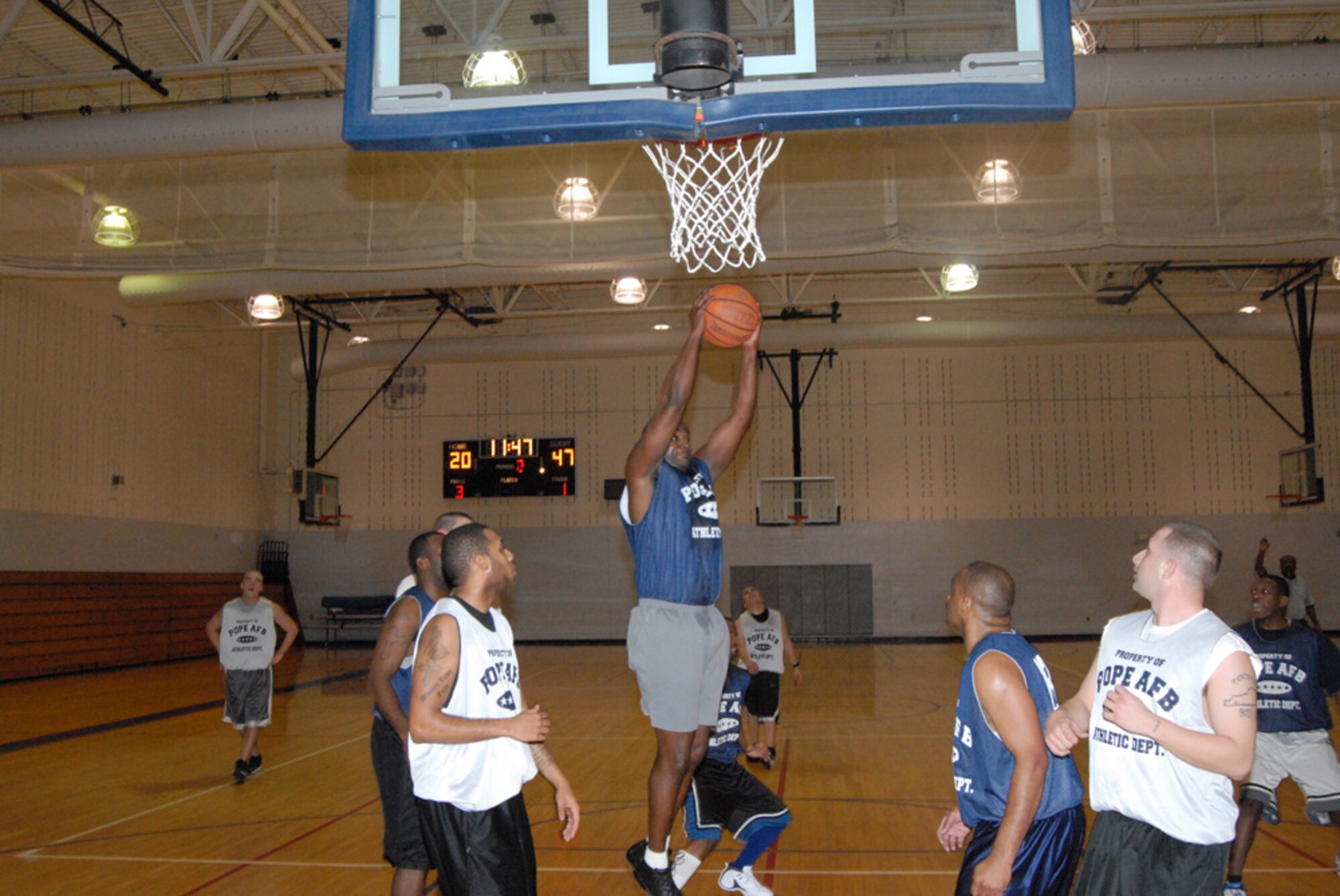 Dobie Strong, 43rd Logistics Readiness Squadron, grabs a rebound during the Jan. 10 70-31 victory for 43rd LRS over 3rd Aerial Port Squadron (2) at the Pope Fitness Center. 