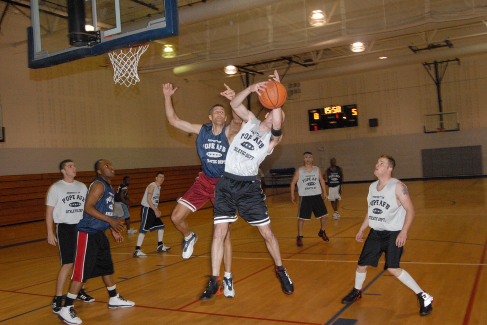 James Mixon, 3rd Aerial Port Squadron, grabs a rebound over Aaron Benson, 43rd Civil Engineer Squadron, during a game Jan. 17 at the Pope Fitness Center. Benson helped 43rd CES get out to a 19-0 lead en route to a 31-7 halftime lead and 61-27 victory. 