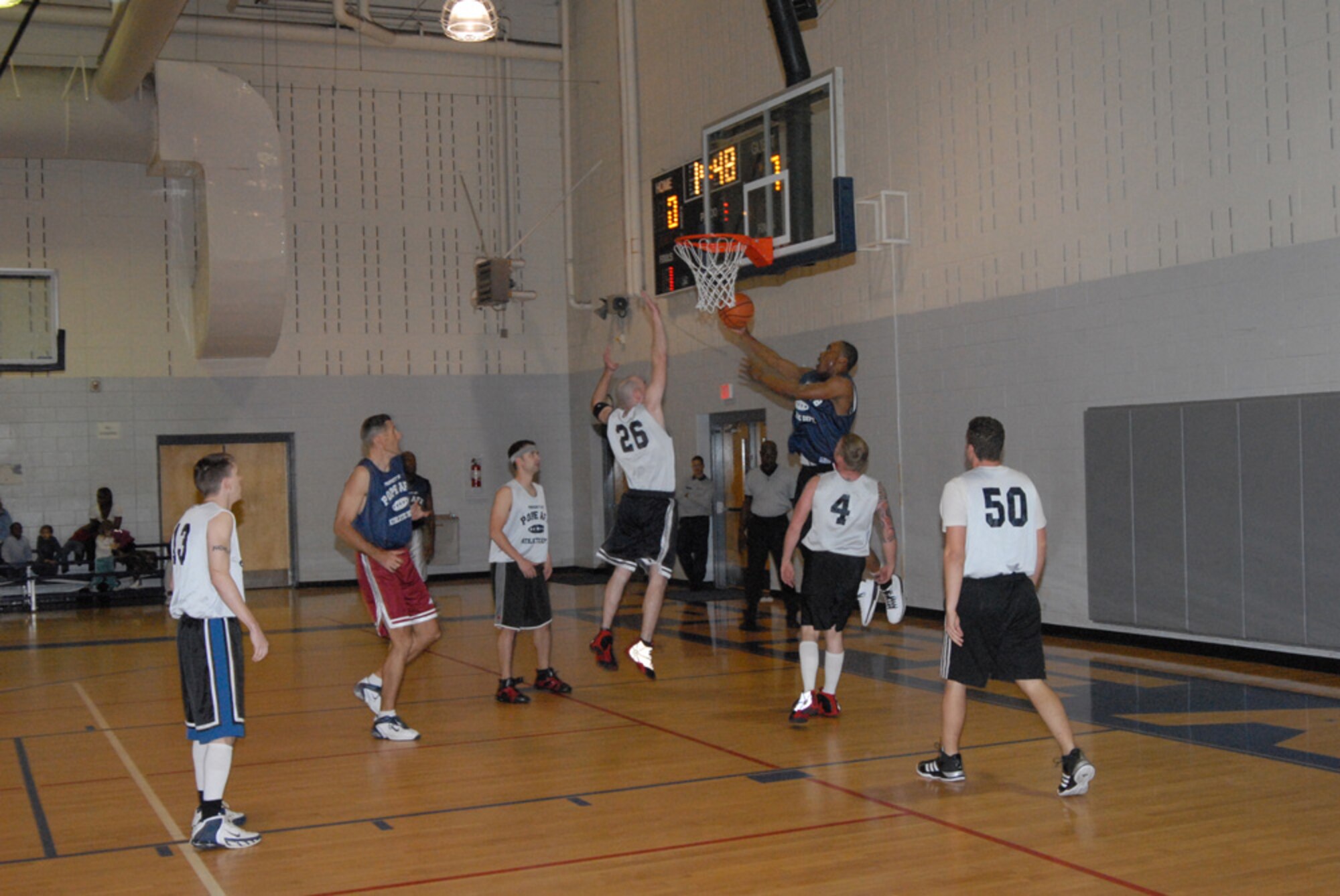 Agusttus Williams, 43rd Civil Engineer Squadron, goes for a reverse layup during the Jan. 17 game against 3rd Aerial Port Squadron (1). 3rd APS did not score their first two points until more than 12 minutes had elapsed in the first half. 