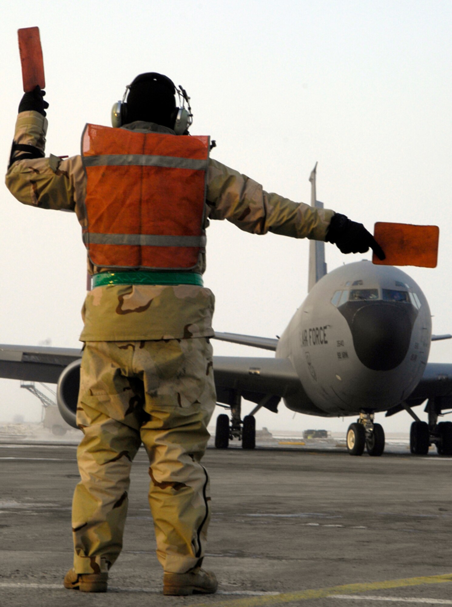 Senior Airman Kevin Caldwell, 376th Expeditionary Aircraft Maintenance Squadron, marshals out a KC-135 on its way to Afghanistan. (U.S. Air Force photo by Senior Airman Tabitha Kuykendall) 
