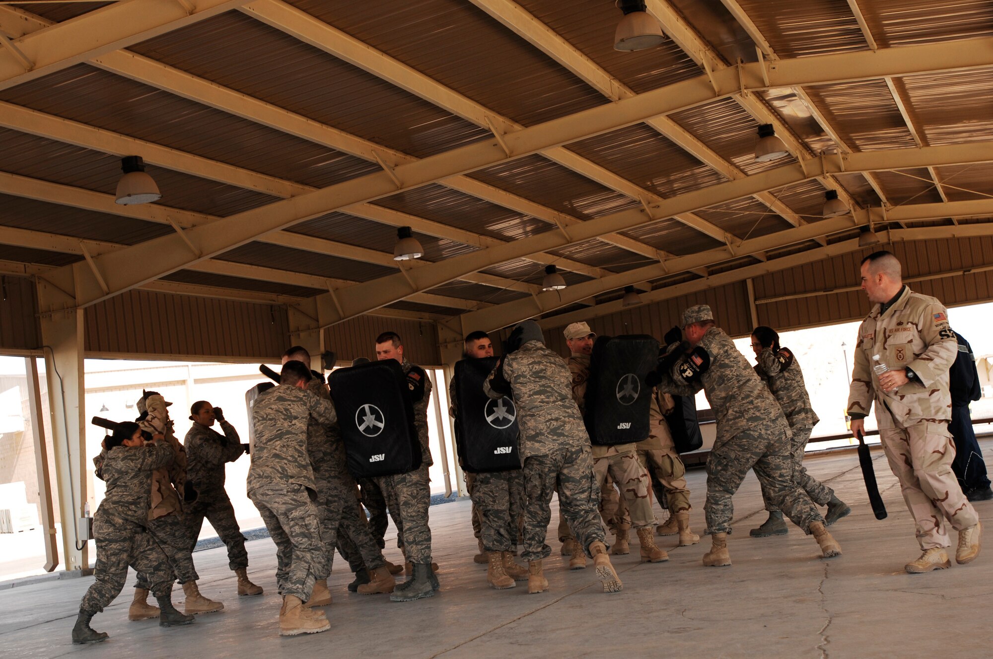 SOUTHWEST ASIA -- Airmen go through drills Jan. 24, 2008, during self defense tactics training with batons at an air base in the Persian Gulf Region. The self defense training familiarizes Airmen with how to use non-lethal force to defend themselves. The Airmen are assigned to the 386th Expeditionary Security Forces Squadron and are deployed in support of Operation Iraqi Freedom. (U.S. Air Force photo/ Senior Airman Patrick Dixon)