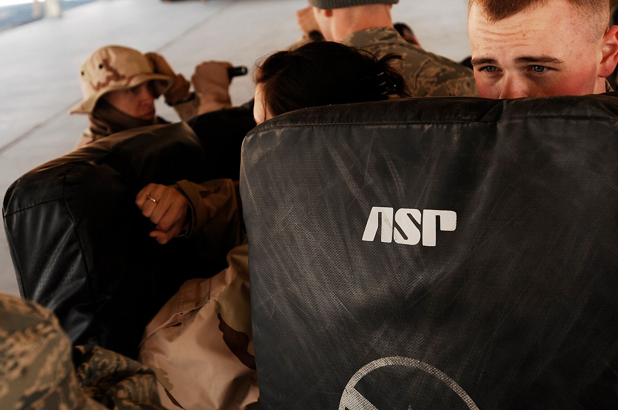 SOUTHWEST ASIA -- Airman 1st Class Dustin May (right), holds a striking pad Jan. 24, 2008, during self defense tactics training with batons for at an air base in the Persian Gulf Region. The self defense training familiarizes Airmen with how to use non-lethal force to defend themselves. Airman May is assigned to the 386th Expeditionary Security Forces Squadron and is deployed in support of Operation Iraqi Freedom. (U.S. Air Force photo/ Senior Airman Patrick Dixon)