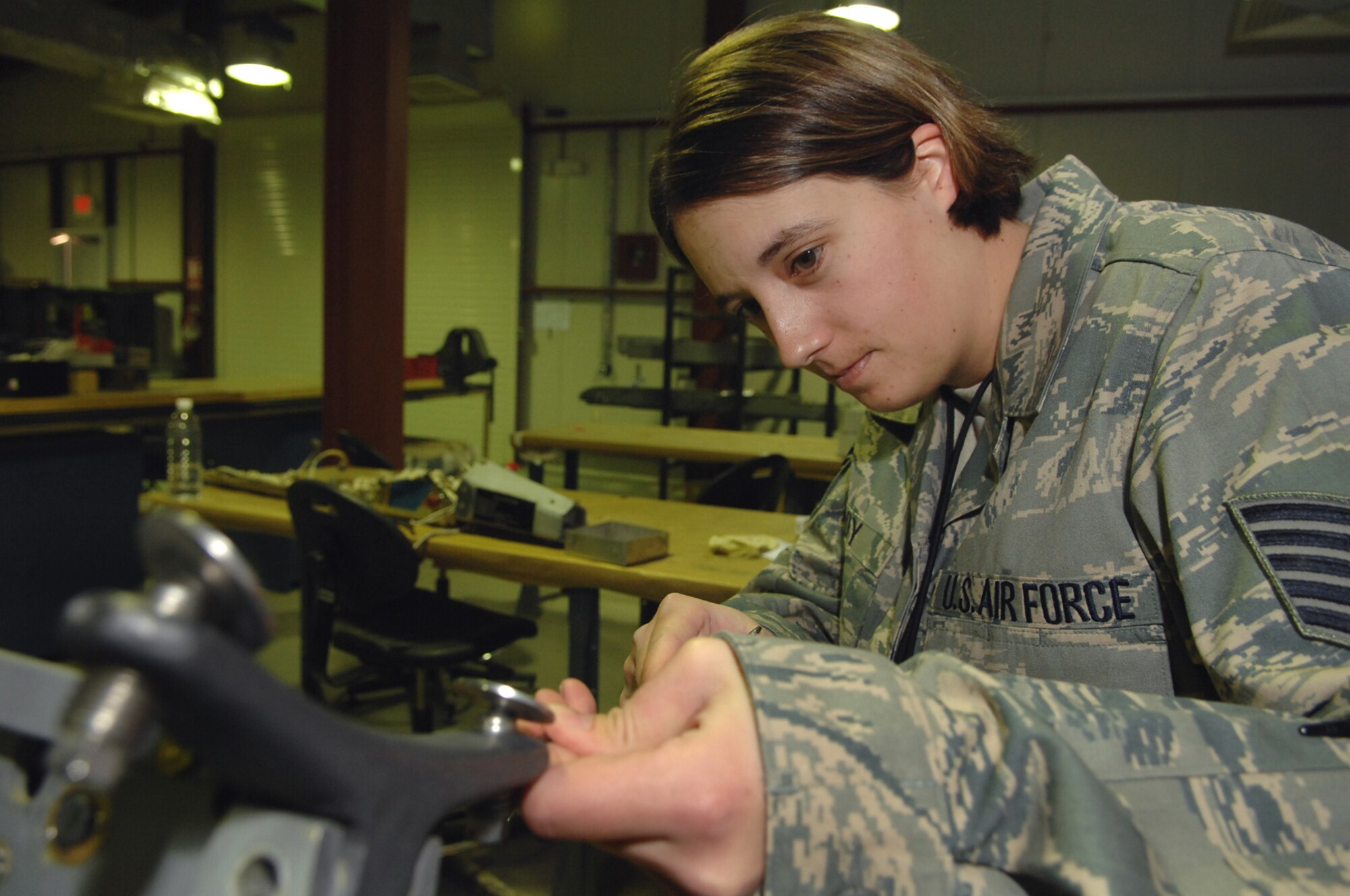 BALAD AIR BASE, Iraq -- Tech. Sgt. Janelle Gaddy, 332nd Expeditionary Maintenance Squadron weapons armament technician, tightens the sway pads on a Triple Ejection Rack-9 Alpha here, Jan. 25. The TER-9A is a munitions rack designed for F-16 Fighting Falcons and can hold up to 3,000 pounds at any one time. Sergeant Gaddy is deployed from the 419th Air Force Reserve unit out of Hill Air Force Base, Utah. (U.S. Air Force photo/ Senior Airman Julianne Showalter)