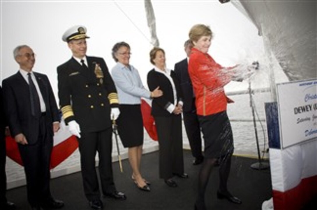 Deborah Mullen christens the Dewey, the newest Aegis-class destroyer, with a bottle of champange across its bow during a ceremony at Northrup Grumman Systems Shipyard, Pascagoula , Miss., Jan. 26, 2008. Mullen is the wife of Navy Adm. Michael G. Mullen, chairman of the Joint Chiefs of Staff.