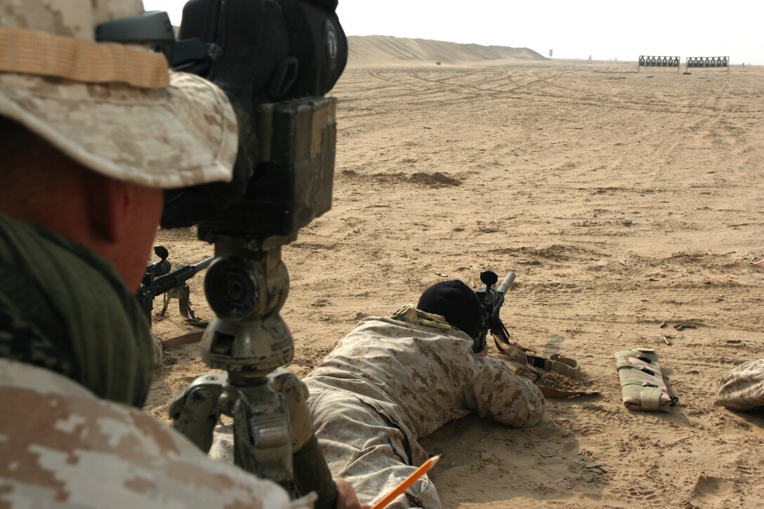 UDAIRI RANGE COMPLEX, Kuwait?A spotter observes the shot group of a scout sniper Jan. 26, here, during a ten-day training package headed by National Sniper Champion Todd Hodnett who taught the Marines how to improve their lethality with new shooting formulas, shooting positions and techniques.