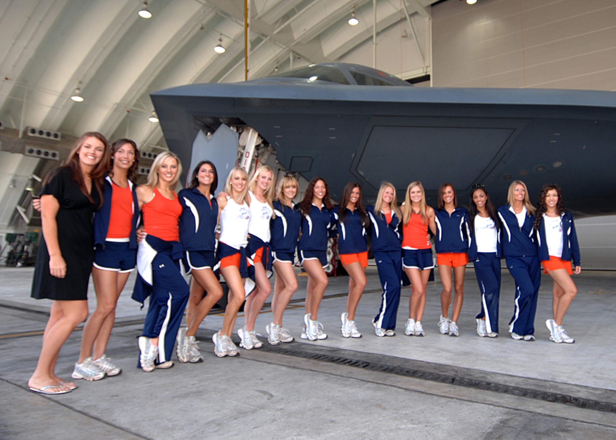 Andersen AFB, Guam -- The Denver Broncos cheerleaders pose in front of a  B-2 Spirit bomber after their visit with the 393rd Expeditionary Bomb Squadron, deployed from Whiteman Air Force Base, Mo. January 25, 2008. (U.S. Air Force Photo by Staff Sgt. Vanessa Valentine) 