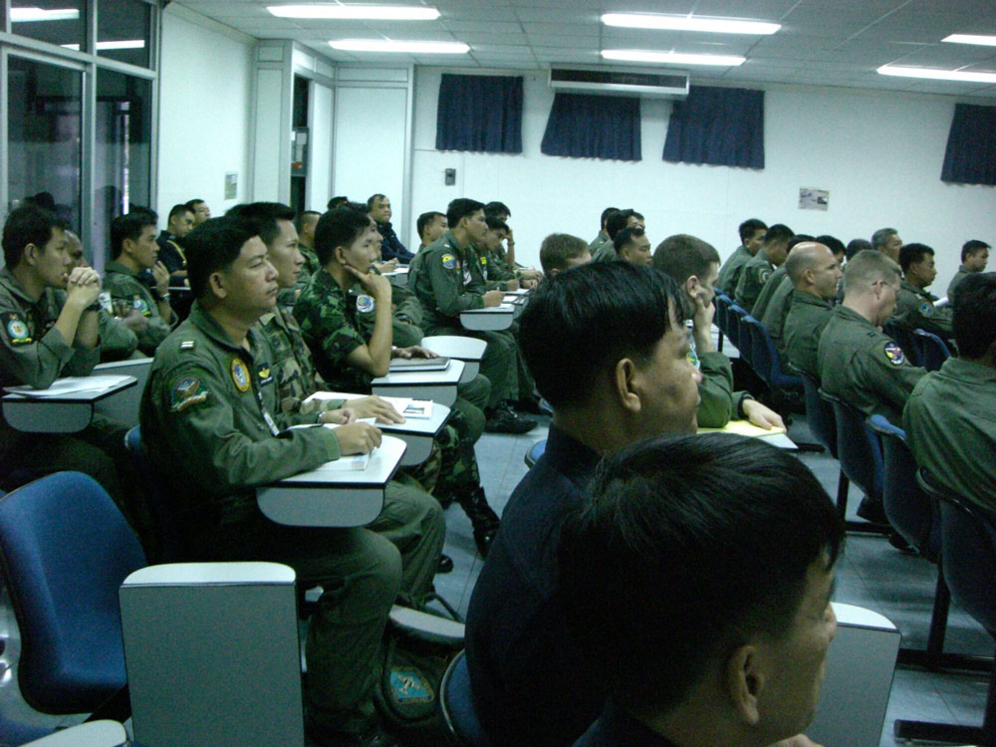 KORAT ROYAL THAI AIR BASE, Thailand -- Pilots and aircrew of the Royal Thai Air Force, Republic of Singapore Air Force, U.S. Air Force, and the U.S. Marine Corps review the initial Cope Tiger daily flying operations briefing here Jan. 27. Cope Tiger is a multilateral joint and combined field training and humanitarian and civic assistance exercise involving Thailand, Singapore and the United States. The Thai-, Singaporean-,  and U.S.-hosted exercise enhances combined readiness and interoperability, reinforces U.S. commitment to the Southeast Asian region, and demonstrates U.S. capability to project combined and joint forces strategically in a multilateral environment. (U.S. Air Force photo by Capt. Renee Lee)