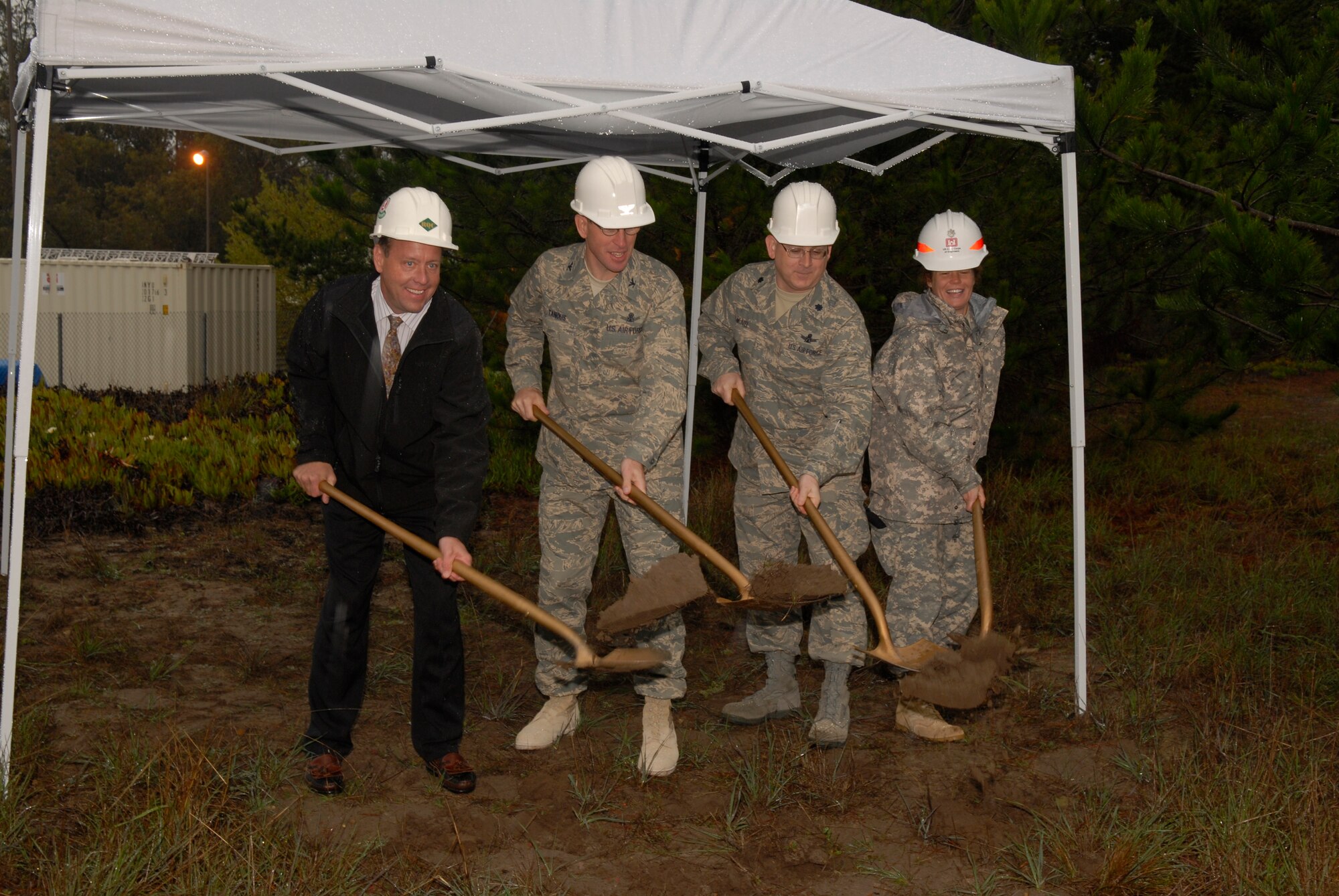 VANDENBERG AIR FORCE BASE, Calif -- Mr. Mitch Tharaldson, RQ Construction, Col. Stephen Tanous, 30th Space Wing Commander, Lt. Col. Sam MCneal, 21st Space Operations Commander, and Lt. Col. Martha Kiene, Army Corps of Engineers, break ground to kick off the construction phase of the new Satellite Control Facility on Jan. 23.  The new facility  finds its home at Vandenberg due to the close of Onizuka Air Force Base in Sunnyvale, California where the 21st Space Operations Squadron resides.  The new infrastructure will house command and control instruments as well as satellite operators to support the space mission.  These operations include missile warning systems, meteorological data, NASA launch and re-entry missions, and intelligence related projects.  As many as 500 operations a day can take place using antennas around the world to link to network and satellites which is essential to National Security. (U. S. Air Force photo/Airman 1st Class Adam Guy)