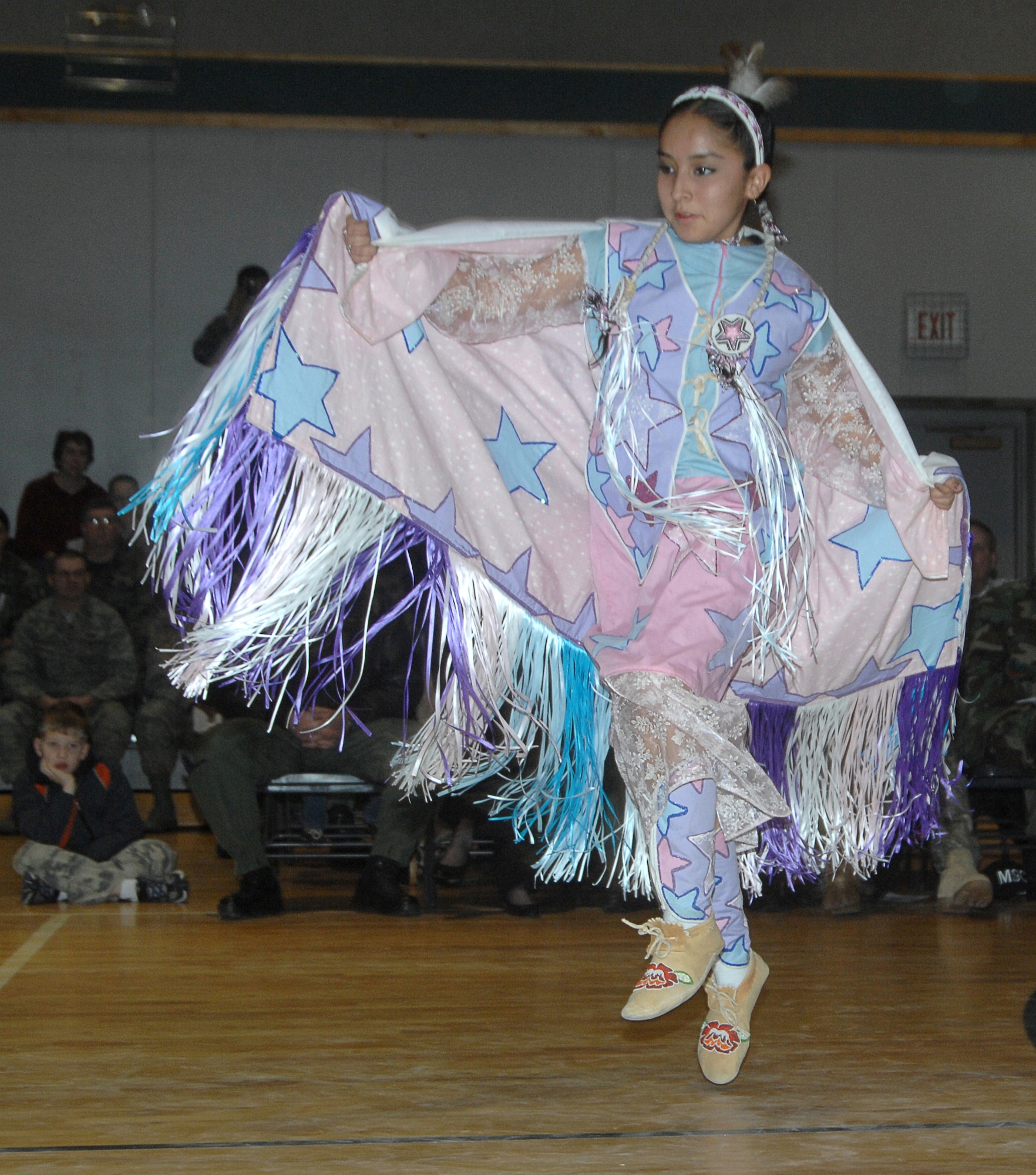 MOUNTAIN HOME AIR FORCE BASE, Idaho – A young member of the Shoshone-Paiute Tribe Dance Group performs a traditional Fancy Dance at the annual pow-wow celebration Jan. 25 at the Youth Center here. This contemporary, free style dance features soaring and swooping moves with men representing birds in flight and women representing graceful butterflies. Approximately 30 tribal members visited the base to perform this and other traditional songs and dances to share their culture with Gunfighters. (U.S. Air Force photo/ Airman 1st Class Stephany Miller)