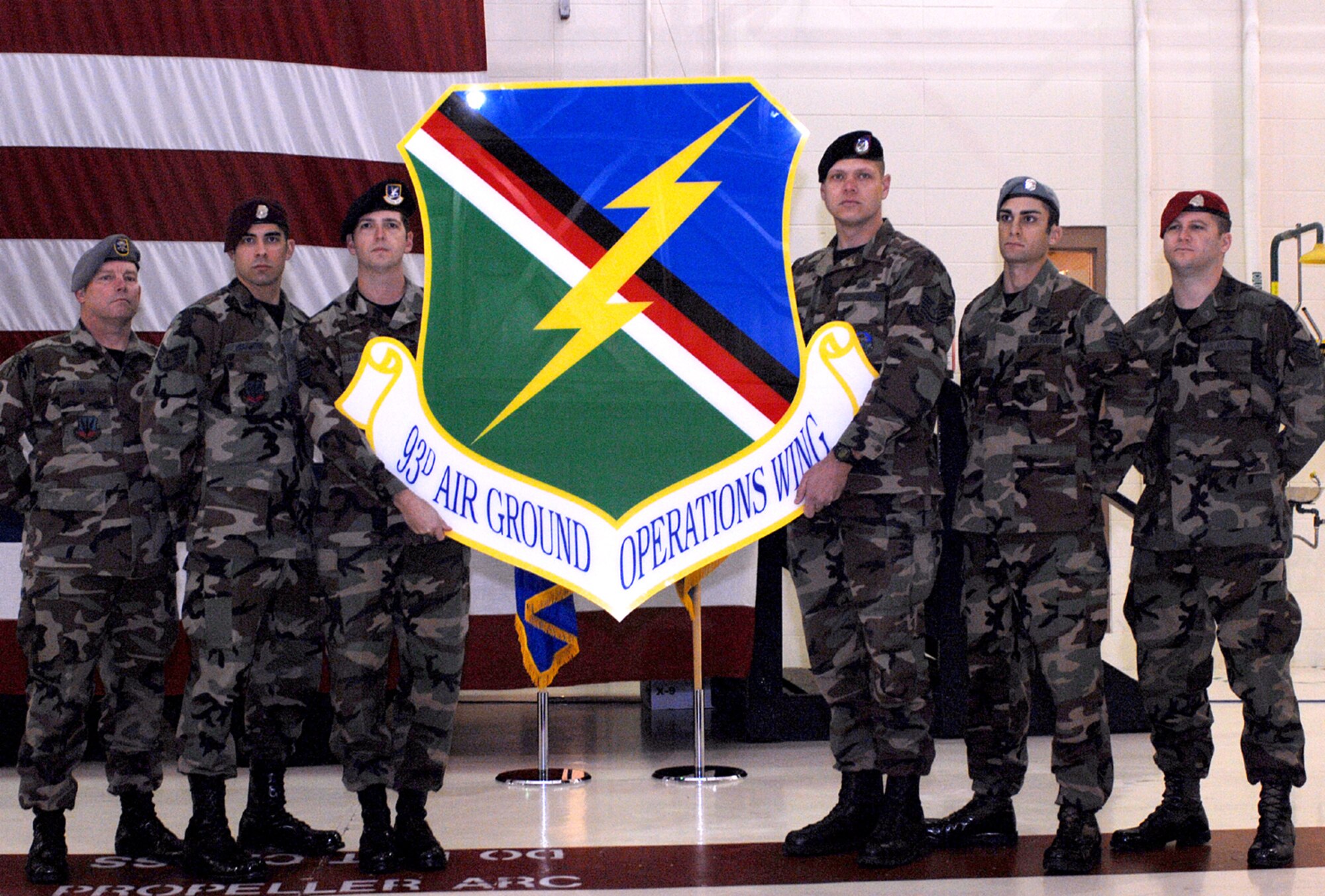 MOODY AIR FORCE BASE, Ga. – A selection of battlefield Airmen pose with the new 93rd Air Ground Operations Wing shield during the wing's activation ceremony here Jan. 25. The 93rd AGOW will bring a new level of support to these specialized Airmen. (U.S. Air Force photo by Senior Airman Angelita Lawrence) 