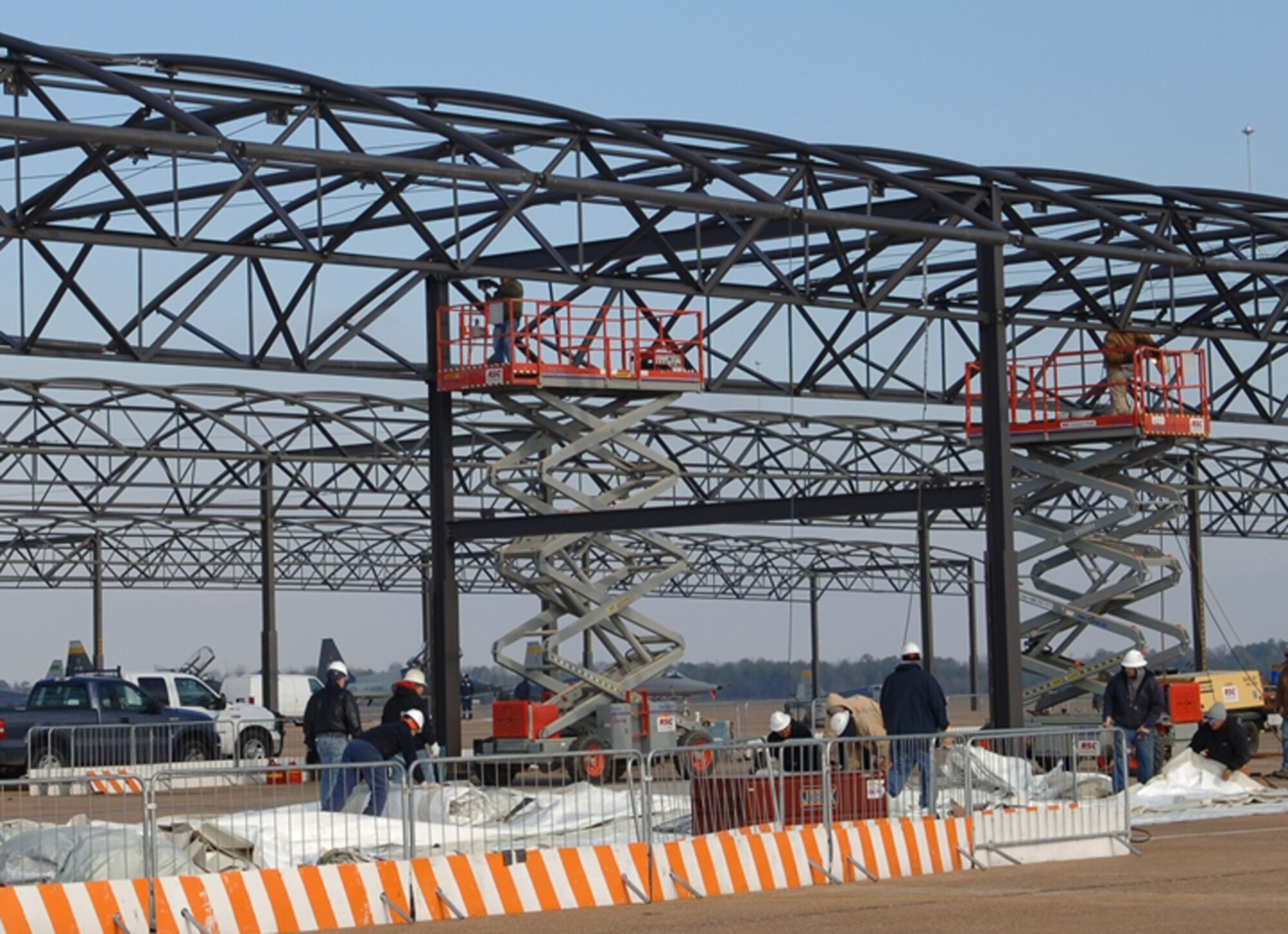 Workers stretch fabric for the sun shelters on the flightline Jan. 24. Sun shelters are designed to reduce heat fatigue of personnel, as well as, reduces temperatures on aircraft that are stored outside. (U.S. Air Force photo by Elizabeth Owens)