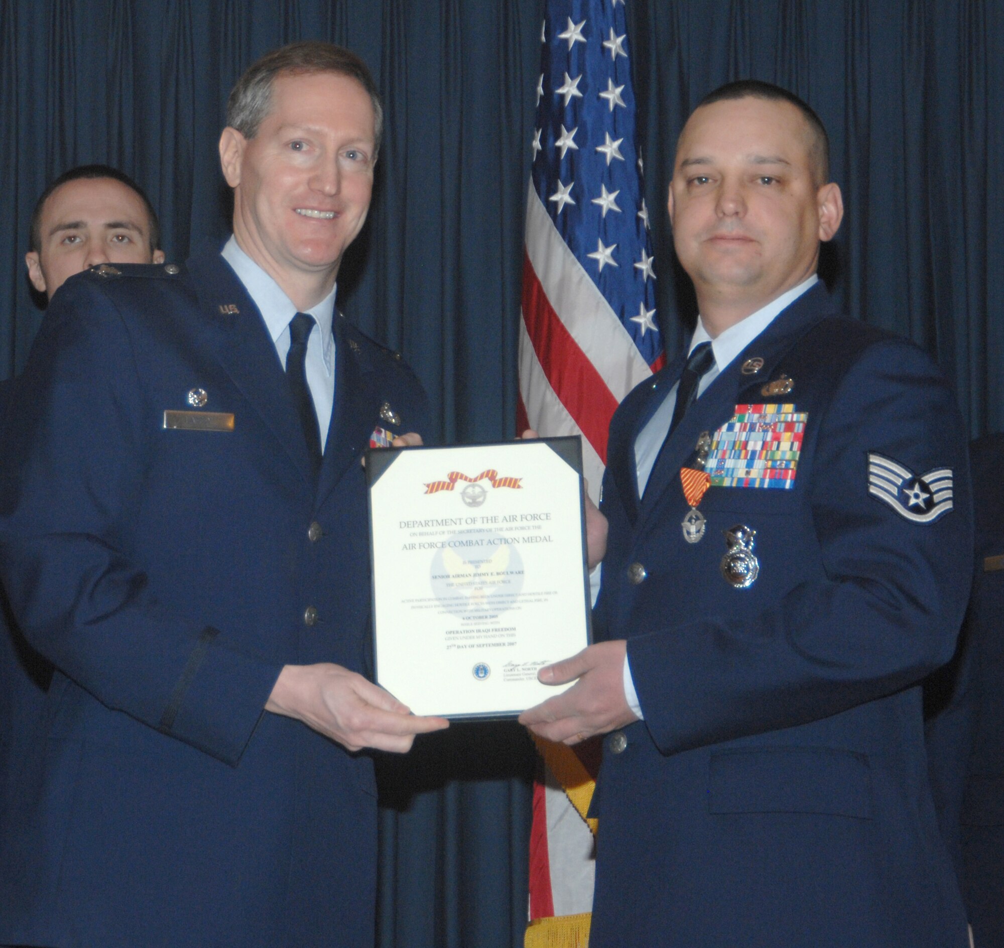 MOUNTAIN HOME AIR FORCE BASE, Idaho -- Left, Col. Thomas Laffey, 366th Mission Support Group commander, presents an Air Force Combat Action Medal to Staff Sgt. Jason Kimberling, 366th Security Forces Squadron, for actions in support of Operation Iraqi Freedom during an awards ceremony at the Gunfighter Club Jan. 25. On Aug. 8, 2006, Sergeant Kimberling was called upon to assist Afghans national police and army in repelling an insurgent attack when a force of over 100 well-trained and well-equipped foreign fighters ambushed three U.S. security forces members and 35 Afghans. His actions were instrumental in eliminating an estimated 20 anti-coalition militants and ensuring zero friendly casualties. Approved on March 15, 2007, the medal recognizes Airmen who actively participated in combat. (U.S. Air Force photo/Airman 1st Class Stephany Miller)
