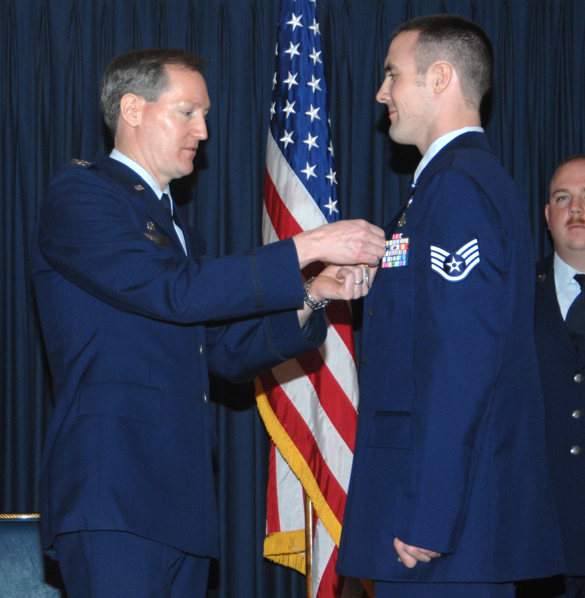 MOUNTAIN HOME AIR FORCE BASE, Idaho -- Left, Col. Thomas Laffey, 366th Mission Support Group commander, presents an Air Force Combat Action Medal to Staff Sgt. Jonathan Salisbury, 366th Civil Engineer Squadron, for actions in support of Operation Iraqi Freedom during an awards ceremony at the Gunfighter Club Jan. 25. On May 25, 2006, Sergeant Salisbury’s forward operating base came under direct fire. Upon hearing the incoming fire, the sergeant assumed a defensive position and returned fire. When the fire halted, Sergeant Salisbury remained in an over-watch position while the quick reaction force assessed the situation. Approved on March 15, 2007, the medal recognizes Airmen who actively participated in combat. (U.S. Air Force photo/Airman 1st Class Stephany Miller)
