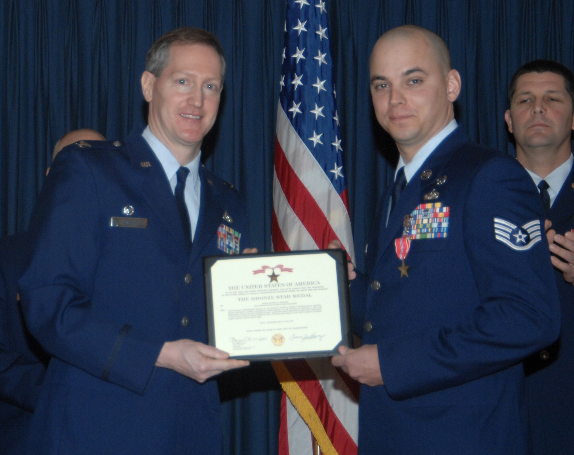 MOUNTAIN HOME AIR FORCE BASE, Idaho -- Left, Col. Thomas Laffey, 366th Mission Support Group commander, presents a Bronze Star Medal to Staff Sgt. Andrew Adrian, 366th Civil Engineer Squadron, for actions in support of Operation Iraqi Freedom from Jan. 12 to July 1, 2007, during an awards ceremony at the Gunfighter Club Jan. 25. Sergeant Adrian distinguished himself by exceptionally meritorious conduct in performance of outstanding service to the U.S. as part of the explosive ordnance disposal flight, 447th Expeditionary Civil Engineer Squadron, Sather AB, Iraq, from Jan. 13 to July 1, 2007. First authorized on Feb. 4, 1944, to recognize ground troops, the bronze star is the fourth highest award for bravery, heroism or meritorious service. (U.S. Air Force photo/Airman 1st Class Stephany Miller)
