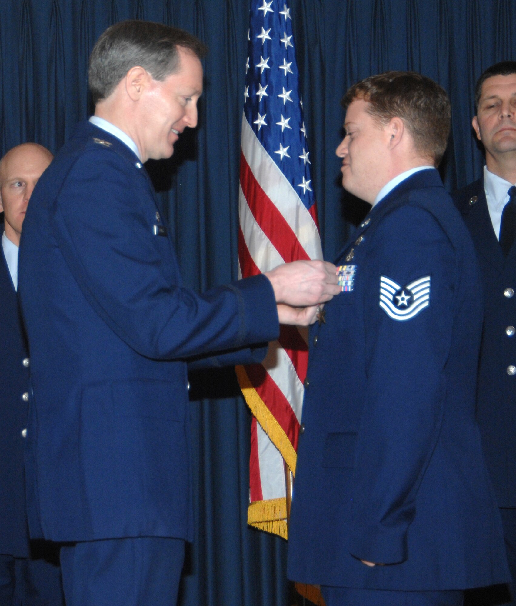 MOUNTAIN HOME AIR FORCE BASE, Idaho -- Left, Col. Thomas Laffey, 366th Mission Support Group commander, presents a Bronze Star Medal to Tech. Sgt. Brandon Bayne, 366th Civil Engineer Squadron, for actions in support of Operation Iraqi Freedom from Jan. 12 to July 1, 2007, during an awards ceremony at the Gunfighter Club Jan. 25. Sergeant Bayne distinguished himself by exceptionally meritorious conduct in performance of outstanding service to the U.S. as part of the explosive ordnance disposal flight, 447th Expeditionary Civil Engineer Squadron, Sather AB, Iraq, from Jan. 13 to July 1, 2007. First authorized on Feb. 4, 1944, to recognize ground troops, the bronze star is the fourth highest award for bravery, heroism or meritorious service. (U.S. Air Force photo/Airman 1st Class Stephany Miller)