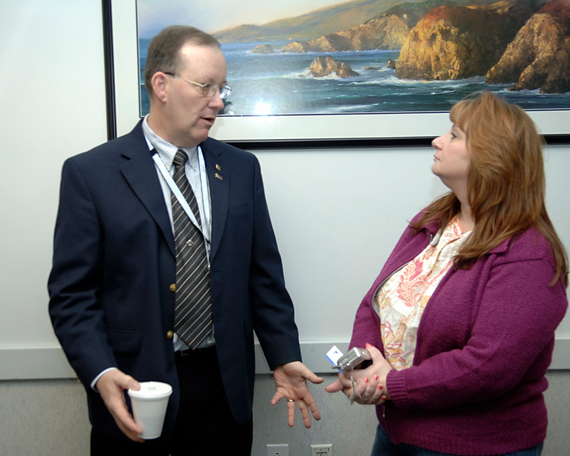 HANSCOM AFB, Mass. – Italia Minchello (right), 66th Air Base Wing Voluntary Protection Program, Team leader, gets information from Dave Caswell, DoD VPP Center of Excellence, at a Meet and Greet session hosted by the Occupational Safety and Health Administration on Jan. 24 in Boston, Mass.  The session offered attendees the opportunity to listen to and ask questions of OSHA personnel who will be inspecting the base's program. (U.S. Air Force photo by Jan Abate)