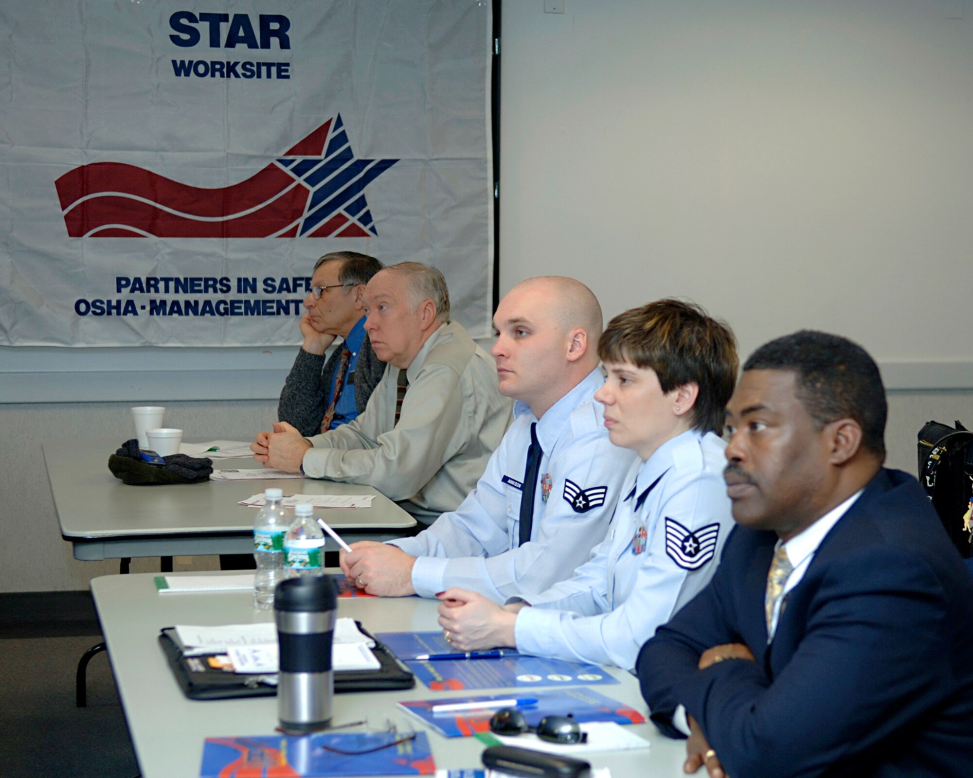 HANSCOM AFB, Mass. – Members of Hanscom’s Voluntary Protection Program team traveled to Boston Jan. 24 for a Meet and Greet session hosted by the Occupational Safety and Health Administration. Pictured here from right to left, VPP team members Galen Williams, 554th Electronic Systems Wing, TSgt. Corina Carrillo and SrA James Annison, 66th Comptrollers Squadron, Ed Luna, 66th Services Squadron and John Federici, 66th Mission Support Group, listen to one of the sessions’ briefings. (U.S. Air Force photo by Jan Abate)