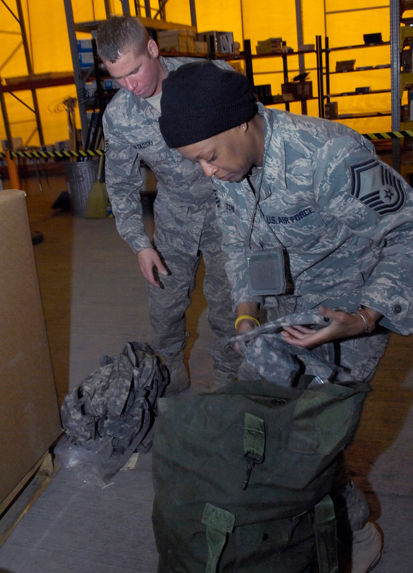 Senior Master Sgt. Yalonda Milton checks her equipment inventory with Staff Sgt. Michael Katkoski Jan. 19 at the 376th Expeditionary Logistics Readiness Squadron at Manas Air Base, Afghanistan. Sergeant Milton is redeploying back to Scott Air Force Base, Ill., after a six-month deployment in Afghanistan. (U.S. Air Force photo/Senior Airman Tabitha Kuykendall) 
