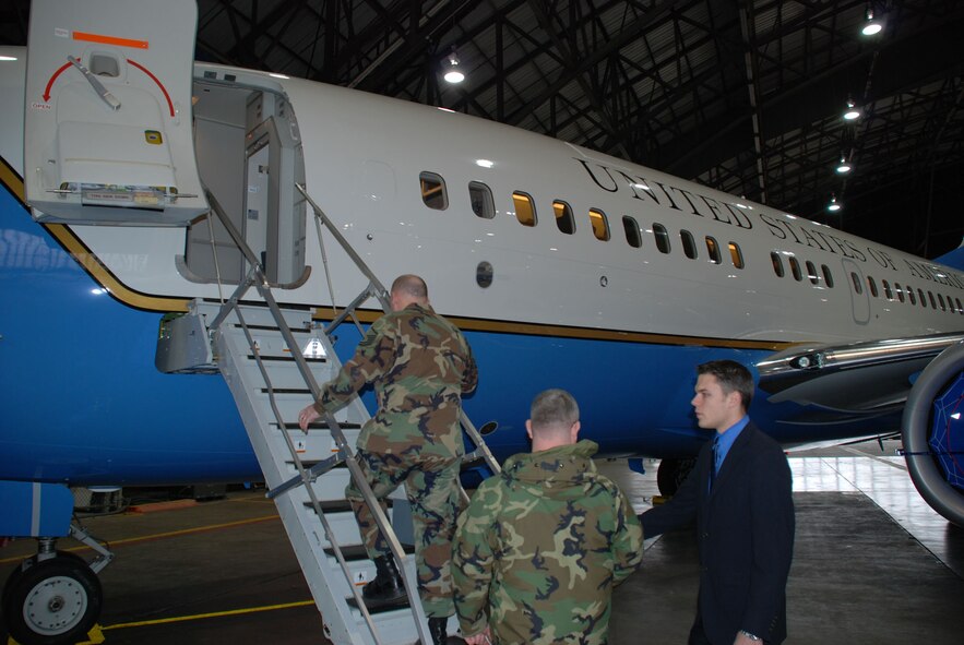 Senior Airman Bob Fourman, a flight attendant with the 73rd Airlift Squadron, 932nd Airlift Wing, speaks to two sergeants about opportunities in the flight attendant program.  Photo/Capt. Stan Paregien