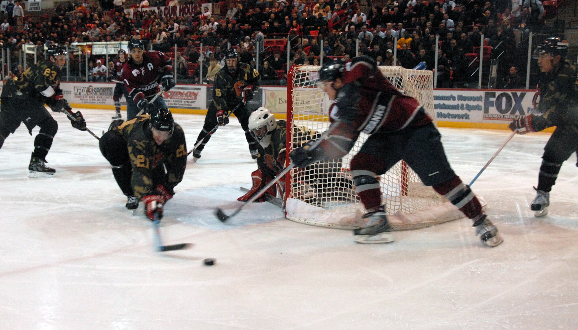 Wichita Falls Wildcats defensemen Sean Duddy tries to make a defensive stop Jan. 26 during the teams military appreciation night game against the visiting Fairbanks Ice Dogs. The Wildcats wore specially-made camoflage jerseys to honor the men and women in the armed forces. Wichita Falls lost the game, 4-3. (U.S. Air Force photo/Mike Litteken) 