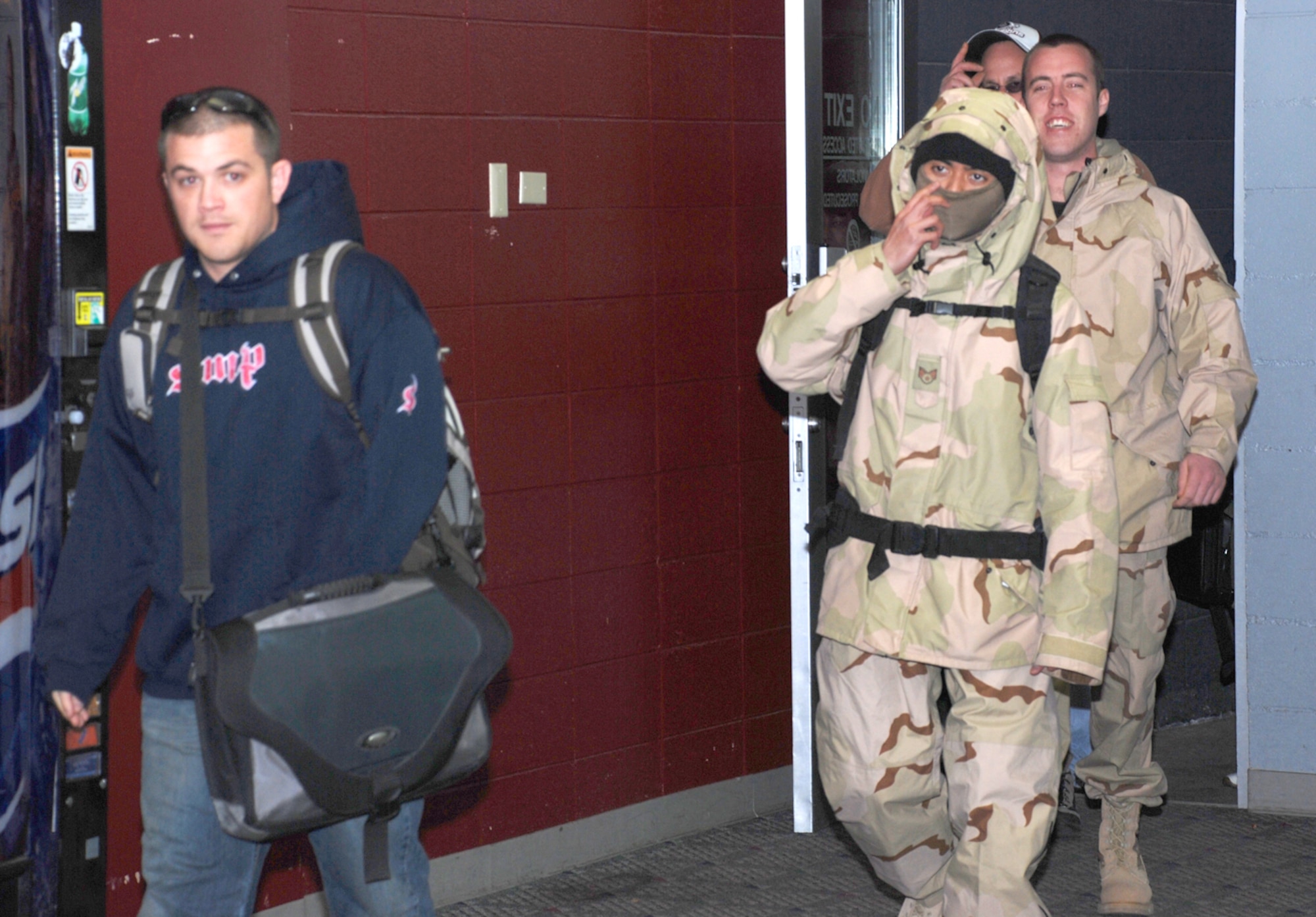 Staff Sgt. Christopher Melton, Senior Airman Froilan Franco, Airman 1st Class Kyle Johnson and Tech. Sgt. John Fisher, all from the 90th Logistics Readiness Squadron, enter the Cheyenne Regional Airport Jan. 16 after their six-month deployment to Balad Air Base, Iraq (U.S. Air Force photo/2nd Lt. Lisa Meiman).