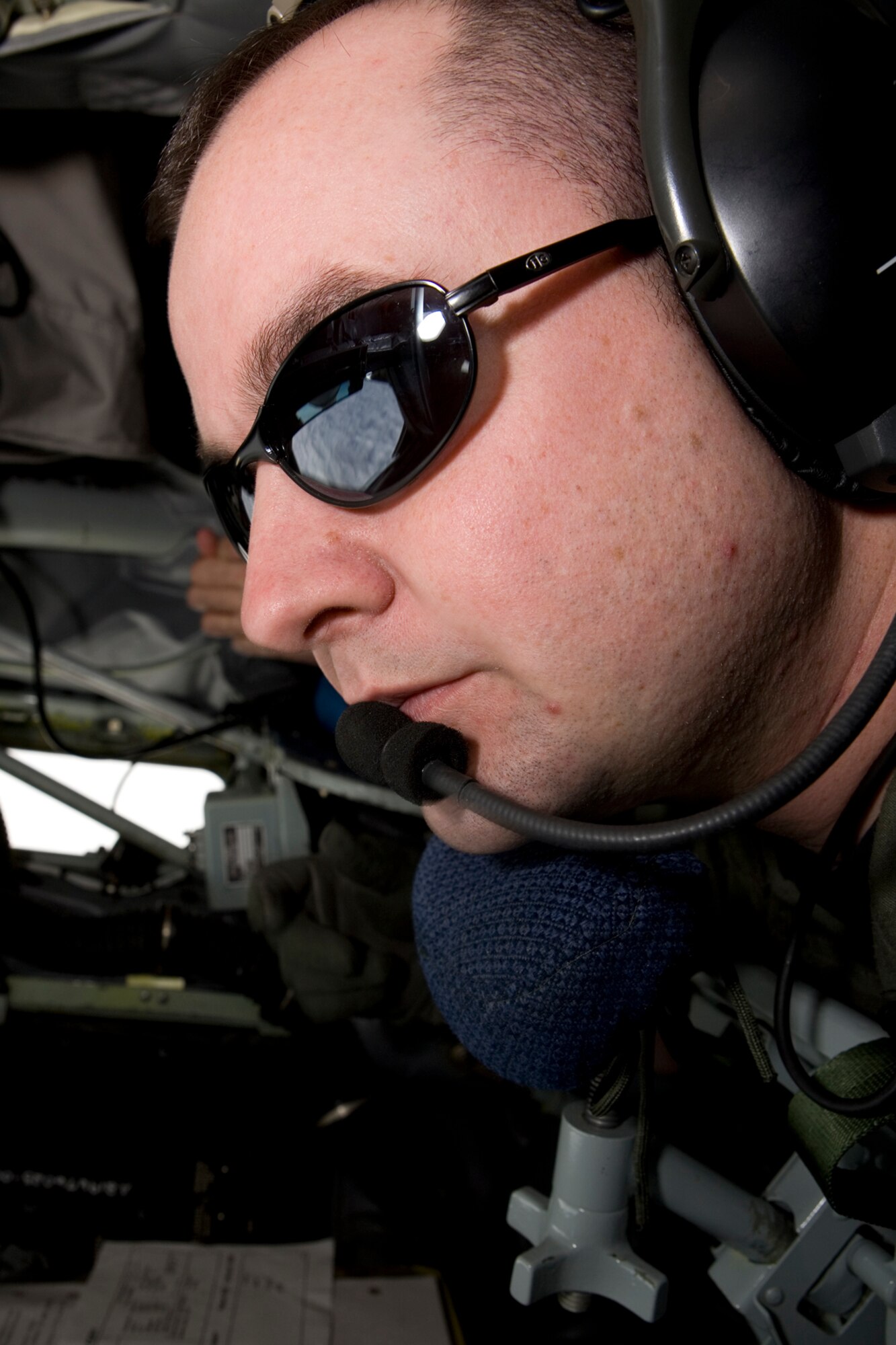 GRISSOM AIR RESERVE BASE, Ind., -- Tech. Sgt. Mike Garman, an inflight refueling technician with the 72nd Air Refueling Squadron, peers out the back of a KC-135R Stratotanker during a recent aerial refueling mission.  During the mid-air refueling process, an inflight refueling technician will transfer thousands of pounds of fuel from the KC-135R Stratotanker to the receiver aircraft.  (U.S. Air Force photo/Senior Airman Omar Delacruz)