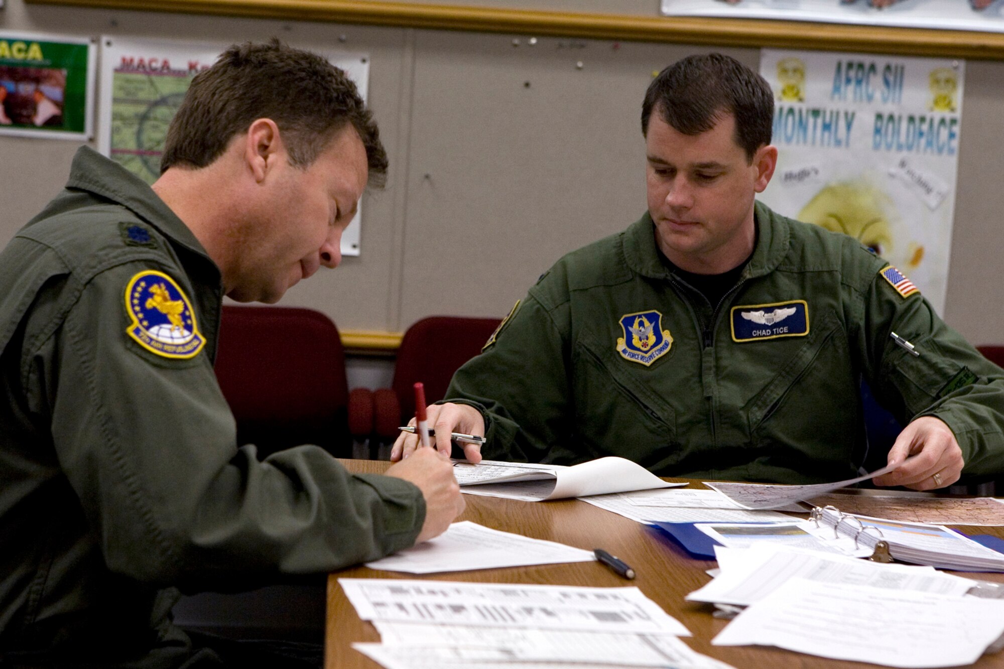 GRISSOM AIR RESERVE BASE, Ind., -- Lt. Col. Dave Mitchell, left, and 1st Lt. Chad Tice, both pilots with the 72nd Air Refueling Squadron, conduct a pre-flight briefing to discuss the day's aerial refueling mission. Hours of behind the scenes work go into planning, scheduling and preparing for each KC-135R mission flown by members of the 434th Air Refueling Wing. (U.S. Air Force photo/Senior Airman Omar Delacruz)