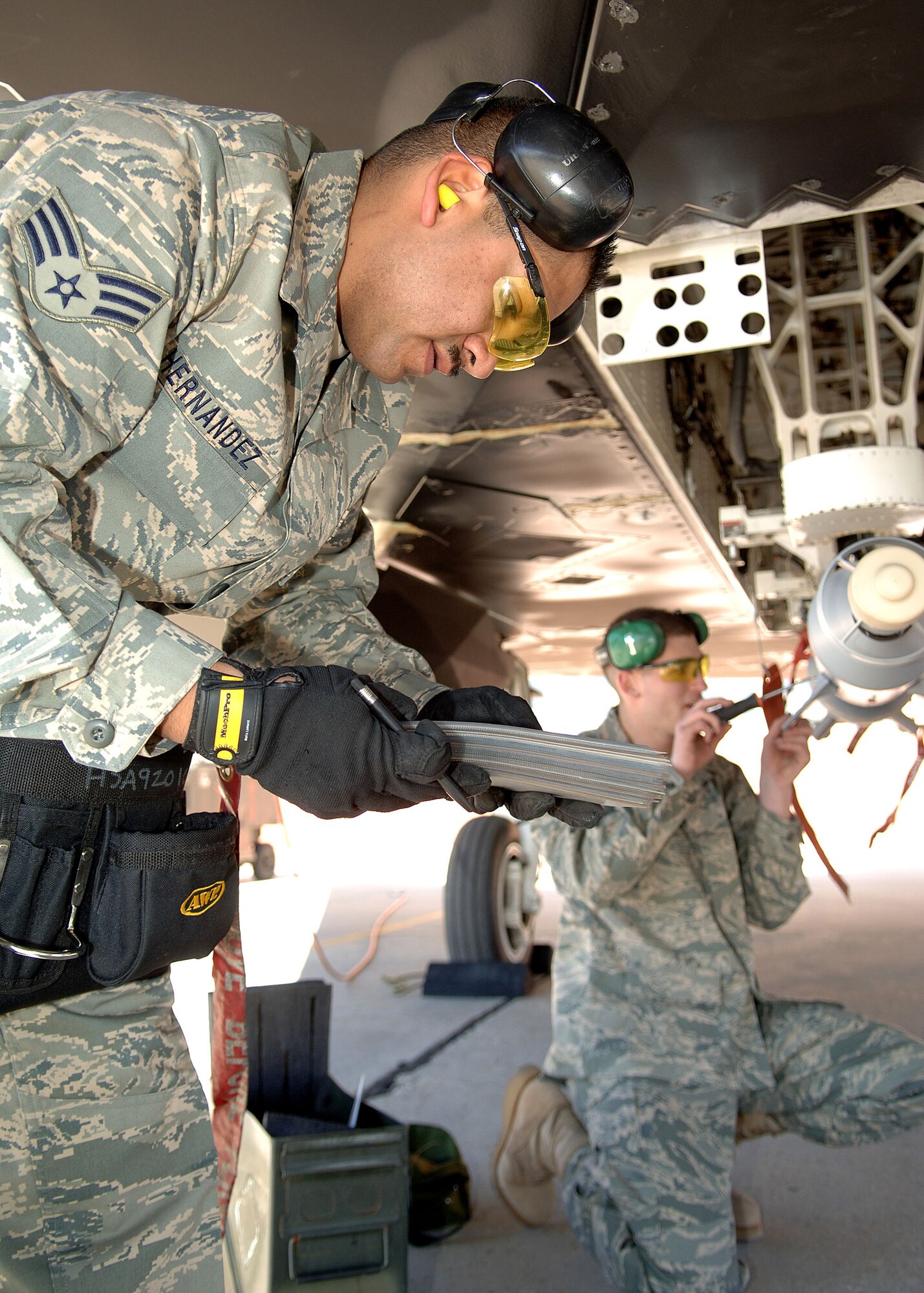 Senior Airman Ignacio Hernandez and Airman 1st Class Kyle Davey  finish their final check on a guided bomb unit-12 during the F-117 Nighthawk Weapons Load Crew of the Year Competition Jan. 18 at Holloman Air Force Base, N.M. The competition is the last of its kind for the F-117. Airmen Hernandez and Davey are assigned to the 49th Aircraft Maintenance Squadron. (U.S. Air Force photo/Airman 1st Class John D. Strong II) 
