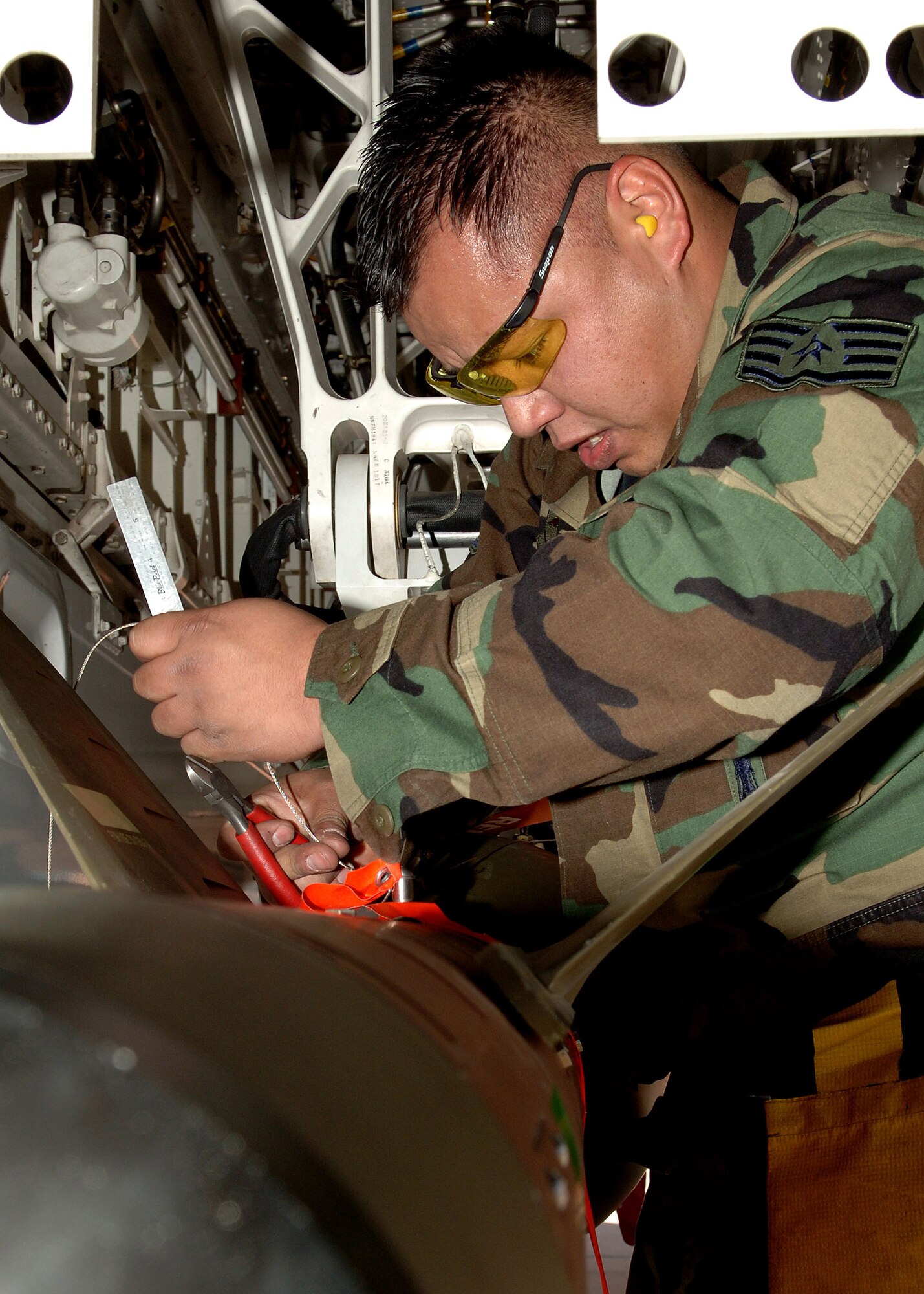 Staff Sgt. Jose Cortez tightens the screws on a guided bomb unit-27 during the F-117 Nighthawk Weapons Load Crew of the Year Competition Jan. 18 at Holloman Air Force Base, N.M. This is the final weapons load crew of the year competition for the F-117 at Holloman AFB. (U.S. Air Force photo/Airman 1st Class John D. Strong II) 
