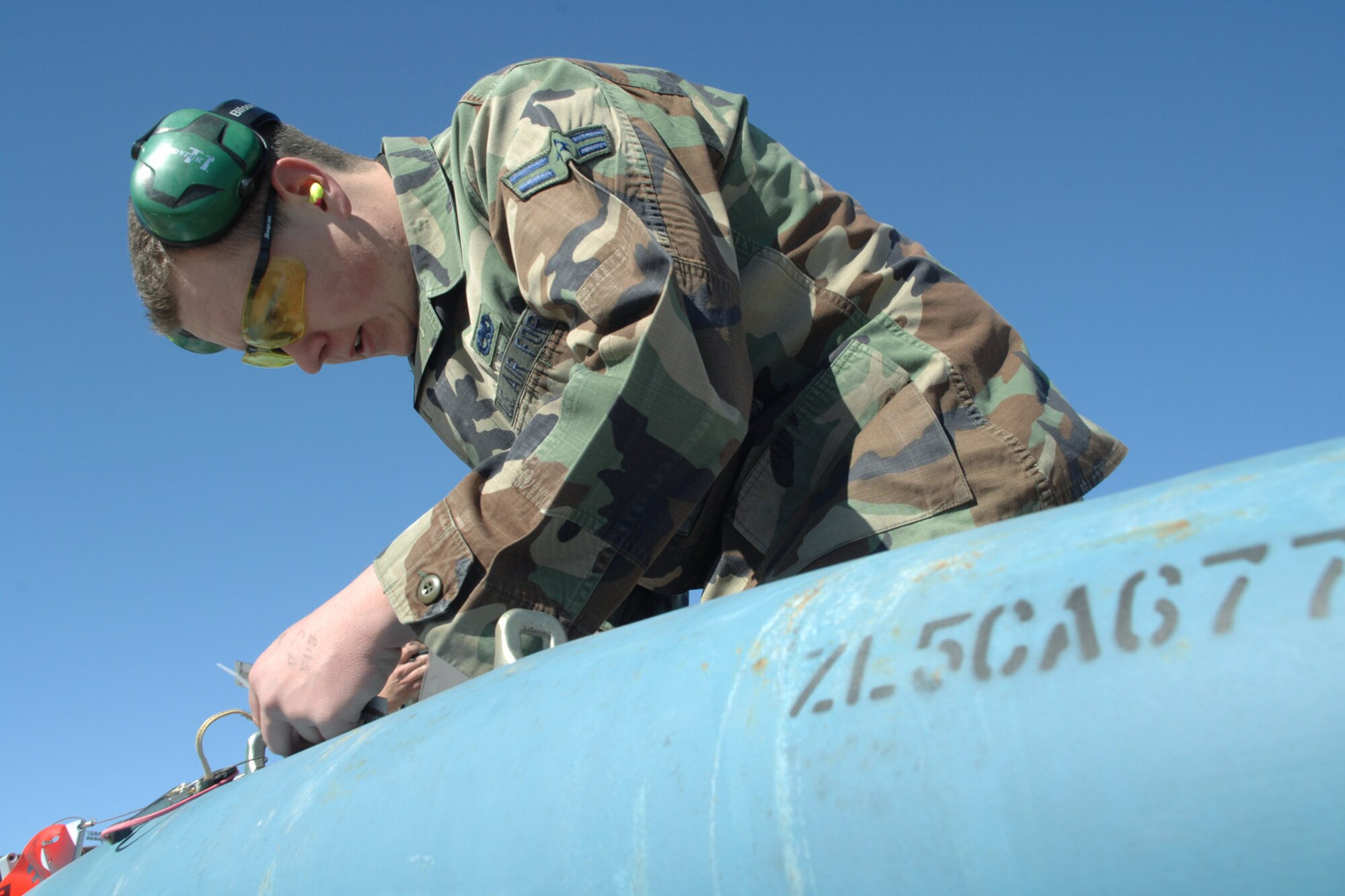 Airman 1st Class Ray Wornat works on a guided bomb unit-12, a 500-pound, general-purpose iron bomb during the F-117 Nighthawk Weapons Load Crew of the Year Competition Jan. 18 at Holloman Air Force Base, N.M. The competition placed the four best weapons load crews (two from the 8th Aircraft Maintenance Unit and two from the 9th Aircraft Maintenance Unit) against each other to determine who the best load crew of the year was. Airman Wornat is assigned to the 49th Aircraft Maintenance Squadron. (U.S. Air Force photo/Airman 1st Class Jamal D. Sutter) 
