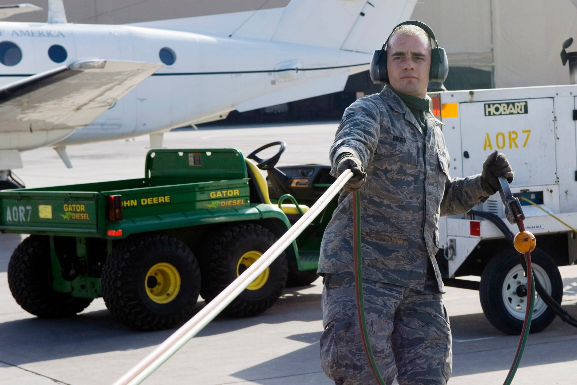 Airman 1st Class Shaun Brodin pulls on the fuel trigger line for more slack Jan. 19 at Balad Air Base, Iraq. The 332nd Expeditionary Logistics Readiness Squadron Fuels Management Flight collectively pumped more than 15 million gallons of gas during their deployment. Airman Brodin, a 332nd ELRS fuels distribution operator, is deployed from Little Rock Air Force Base, Ark. (U.S. Air Force photo/Staff Sgt. Travis Edwards) 
