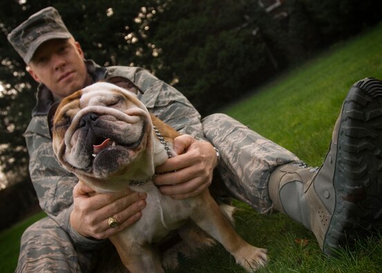 Command Chief Master Sgt. Michael Warner, 100th Air Refueling Wing, explains how his English bulldog, Achilles, squints his eyes tight and shakes his head and tail when greeting a potential new friend, Jan. 25, 2008.