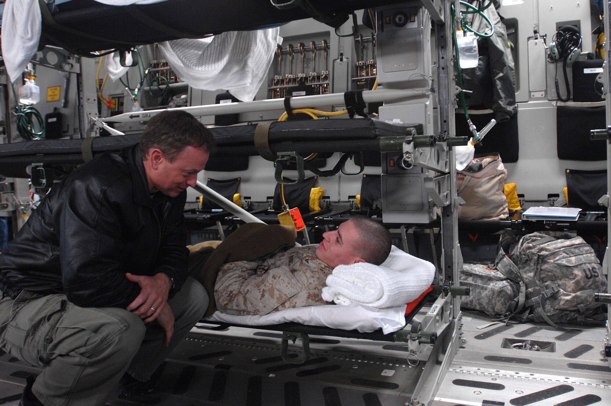 Movie and TV star actor Gary Senise visits with wounded military personal being loaded on to an aeromedical evacuation flight during his recent visit to Ramstein Air Base Jan. 25. Gary Sinise and friends, Medal of Honor recipients, Mike Thornton and Drew Dix, and actor John Ratzenberger visited Ramstein to help boost morale and say thanks for all the great work accomplished by the armed forces. (U.S. Air Force photo/Airman 1st Class Kenny Holston)