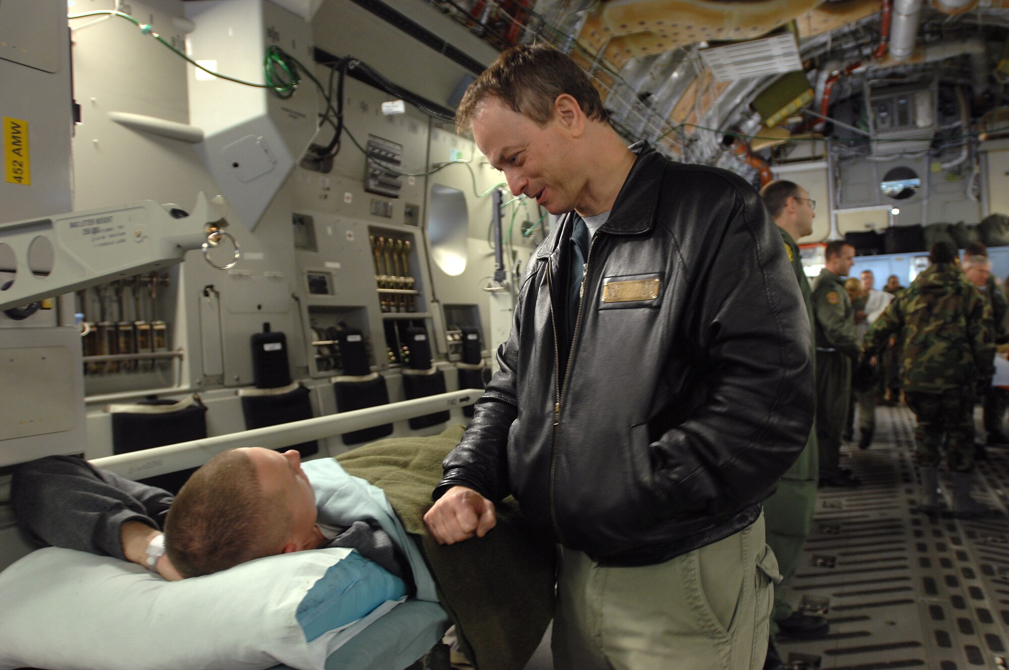 Movie and TV star actor Gary Senise visits with wounded military personal being loaded on to an aeromedical evacuation flight during his recent visit to Ramstein Air Base Jan. 25. Gary and friends, Medal of Honor recipients, Mike Thornton and Drew Dix, and actor John Ratzenberger visited Ramstein to help boost morale and say thanks for all the great work accomplished by the armed forces. (U.S. Air Force photo/Airman 1st Class Kenny Holston)