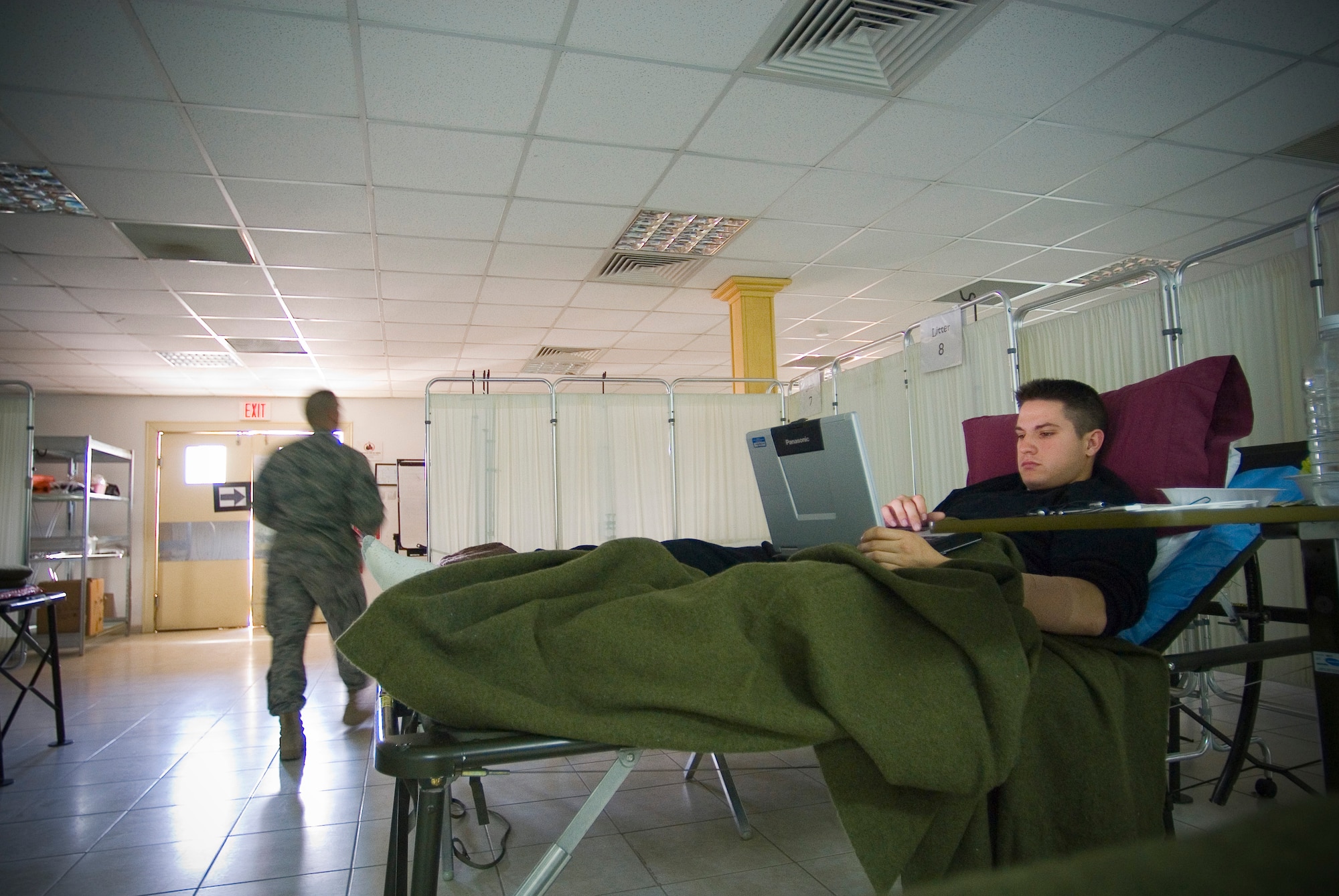 BALAD AIR BASE, Iraq -- Army Pfc. Derek Jon Toysa, an injured member of the 82nd Airborne Division, uses the Contingency Aeromedical Staging Facility's wireless Internet connection here while waiting for aeromedical evacuation to Landstuhl Regional Medical Center, Germany. From hot water to access to phones, the CASF team strives to make patients comfortable as they await follow-on care. (U.S. Air Force photo/ Master Sgt. John Nimmo, Sr.) 