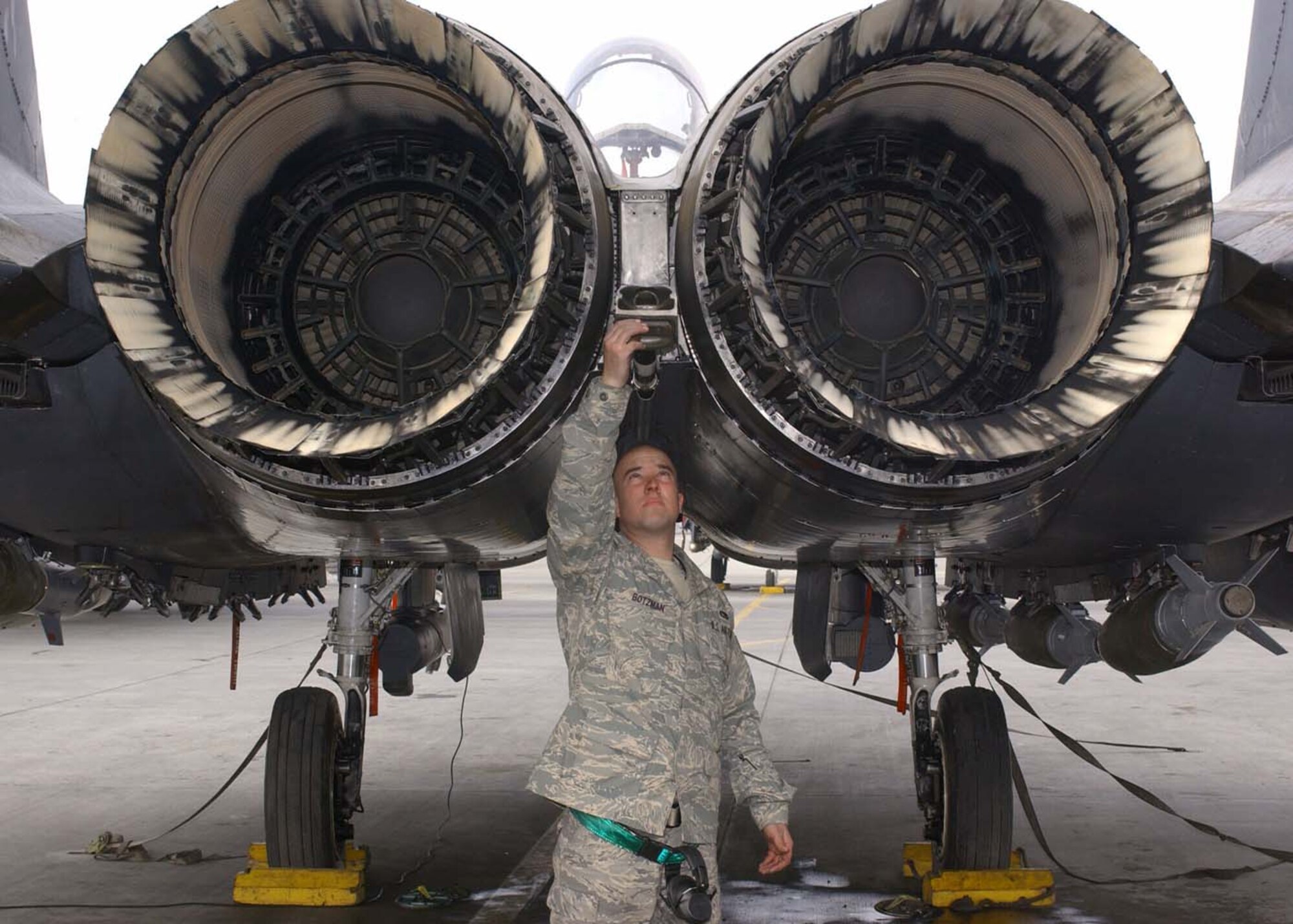 BAGRAM AIR BASE, Afghanistan - Airman 1st Class Erik Botzman, 455th Expeditionary Aircraft Maintenance Squadron tactical aircraft maintenance crew chief, checks the tail hook on an F-15E before a combat sortie Jan. 28.  Botzman's home unit is the 335th Aircraft Maintenance Unit at Seymour Johnson Air Force Base, N.C. (U.S. Air Force photo by Master Sgt. Demetrius Lester)   