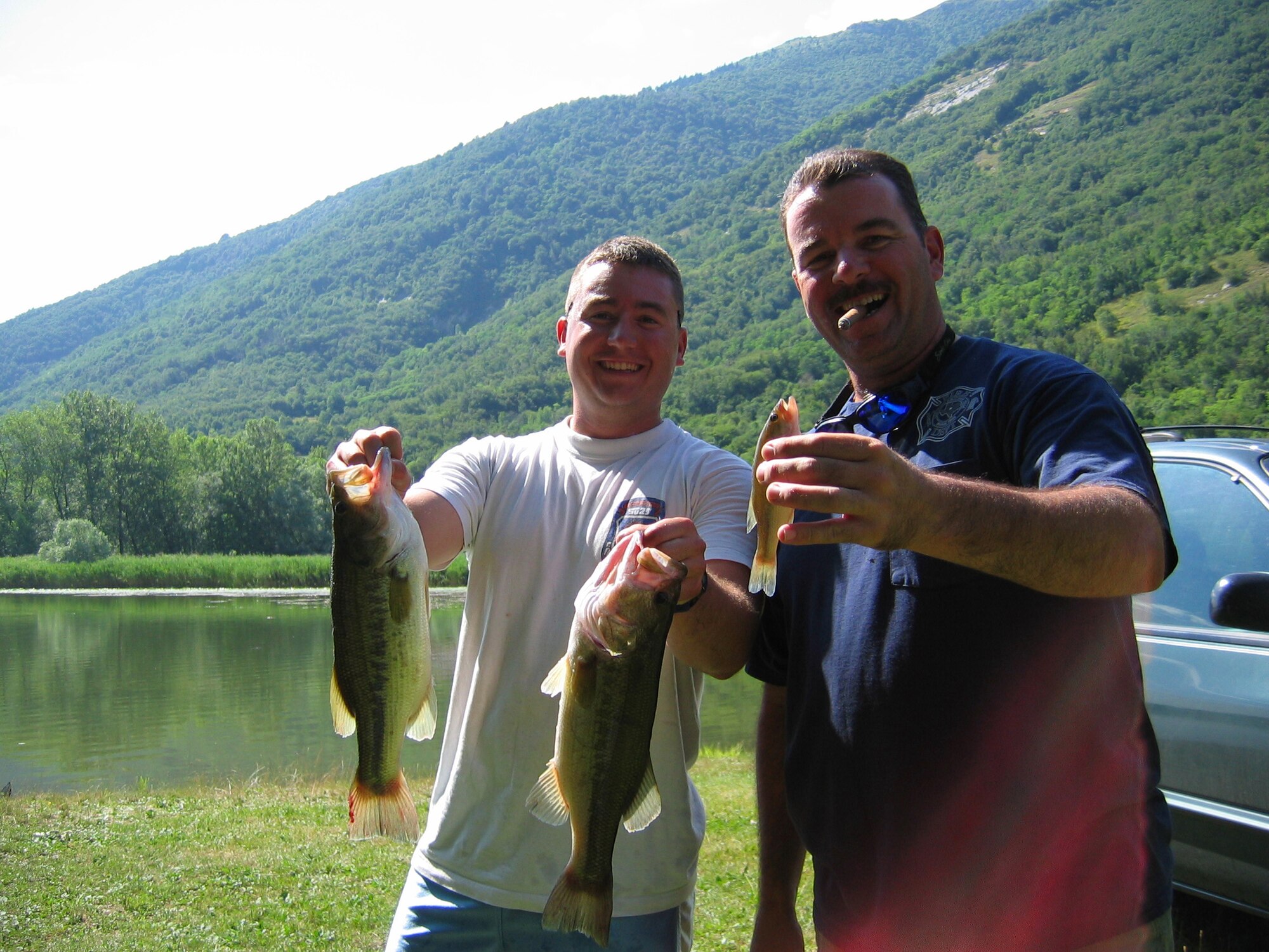 Chief Master Sgt. Randy Marshall, and Staff Sgt. Jamie Erickson, show off their bass during this Team Aviano Bass Busters bass tournament April 13, 2006 Lago di Revine, Italy.  ( Courtesy photo )