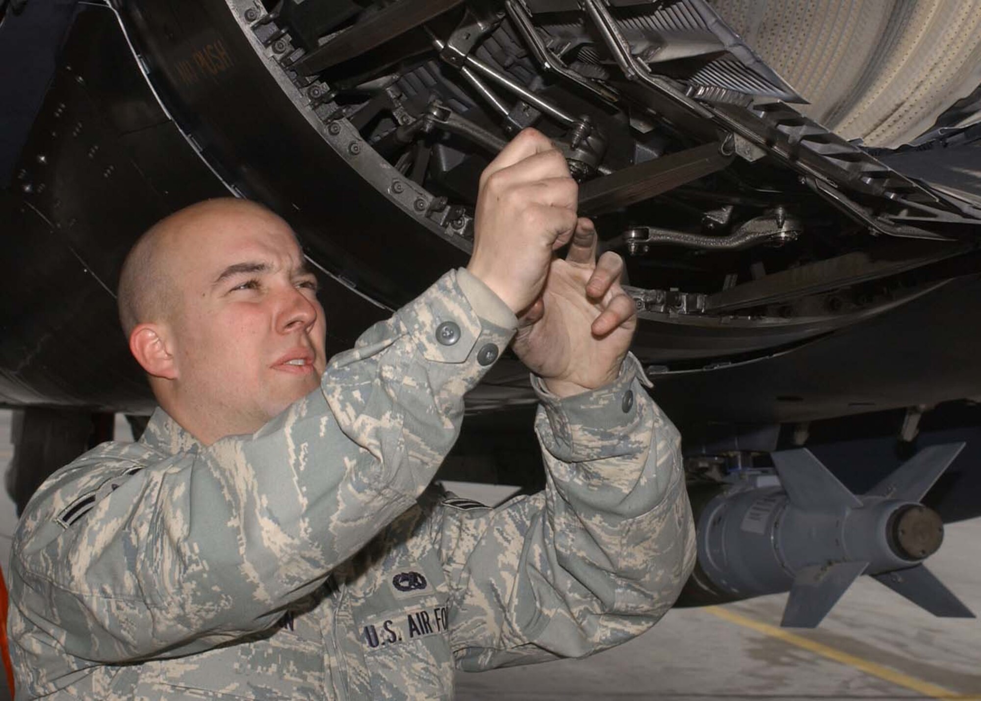 BAGRAM AIR BASE, Afghanistan - Airman 1st Class Erik Botzman, 455th Expeditionary Aircraft Maintenance Squadron tactical aircraft maintenance crew chief, checks the segment and seals on an F-15E engine before a combat sortie Jan. 28. Botzman's home unit is the 335th Aircraft Maintenance Unit at Seymour Johnson Air Force Base, N.C. (U.S. Air Force photo by Master Sgt. Demetrius Lester)