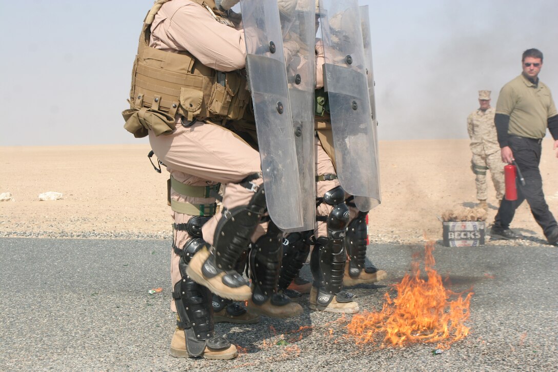 CAMP BUEHRING, Kuwait (Jan. 27, 2008) ? Marines with G Battery, Battalion Landing Team 1st Battalion, 5th Marine Regiment, 11th Marine Expeditionary Unit, practice defending against petrol-bombs, also known as ?Molotov cocktails? during a non-lethal weapons training course here. The 11th MEU, stationed at Camp Pendleton, Calif., is taking part of sustainment training here during their scheduled six-month deployment through the Western Pacific and Arabian Gulf region.