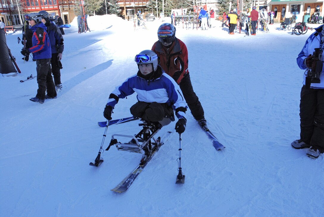Airman 1st Class Kevin Krogh gets guided to the gondola for a ride up the mountain in Keystone, Colo., Jan. 26. Airman Krogh was one of several disabled servicemembers who took advantage of free ski lessons offered during the annual SnoFest military community event. Airman Krogh, who was injured during an automobile accident, is an F-22 Raptor weapons loaders assigned to Langley AFB, Va. (U.S. Air Force photo/Senior Airman Stephen Collier) 