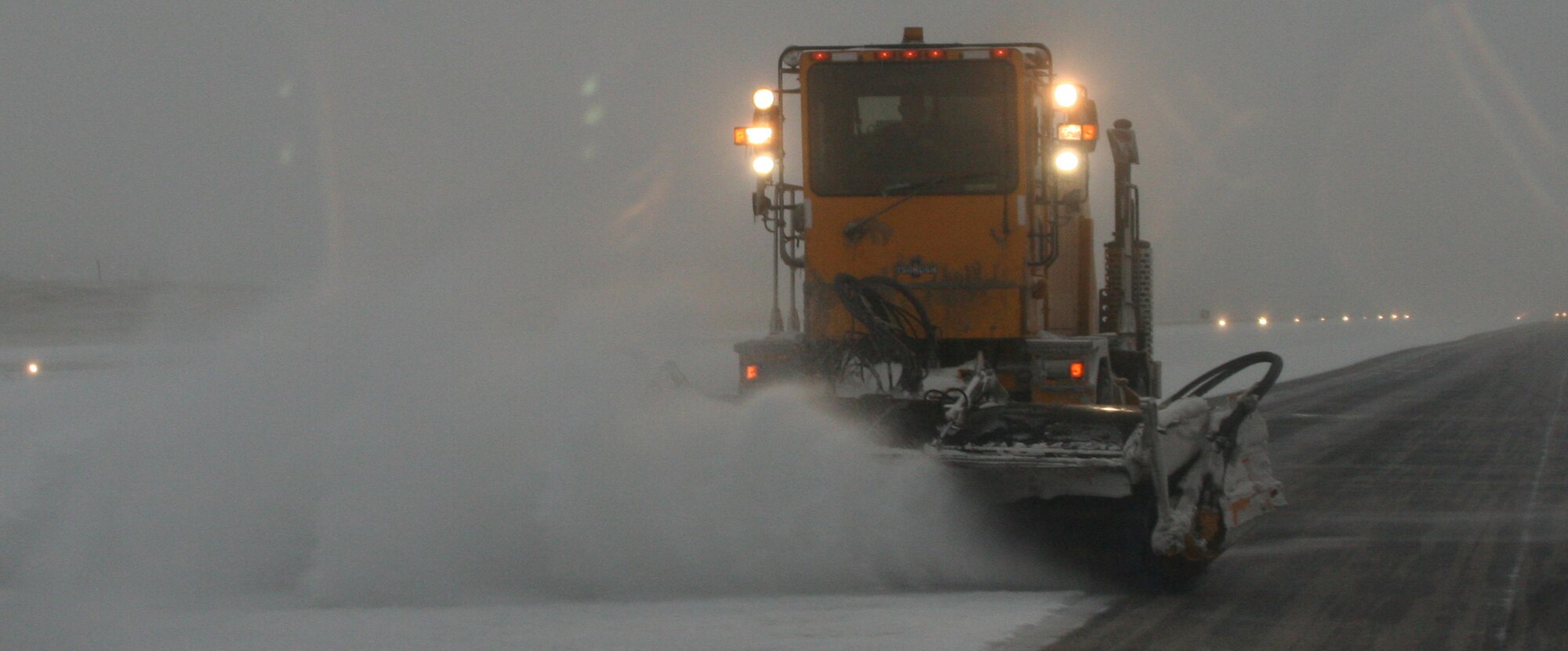 WHITEMAN AIR FORCE BASE, Mo. – A brush truck dusts snow and ice off of the runway Jan. 13, 2007 to ensure the B-2 will be able to complete any mission it is called for. The 509th CES has about 30 pieces of snow removal equipment, to include brush trucks, rollover machines and snow blower trucks. The snow removal crew general uses 12-13 pieces of equipment at a time. (U.S. Air Force photo/Maj. Joe DellaVedova)