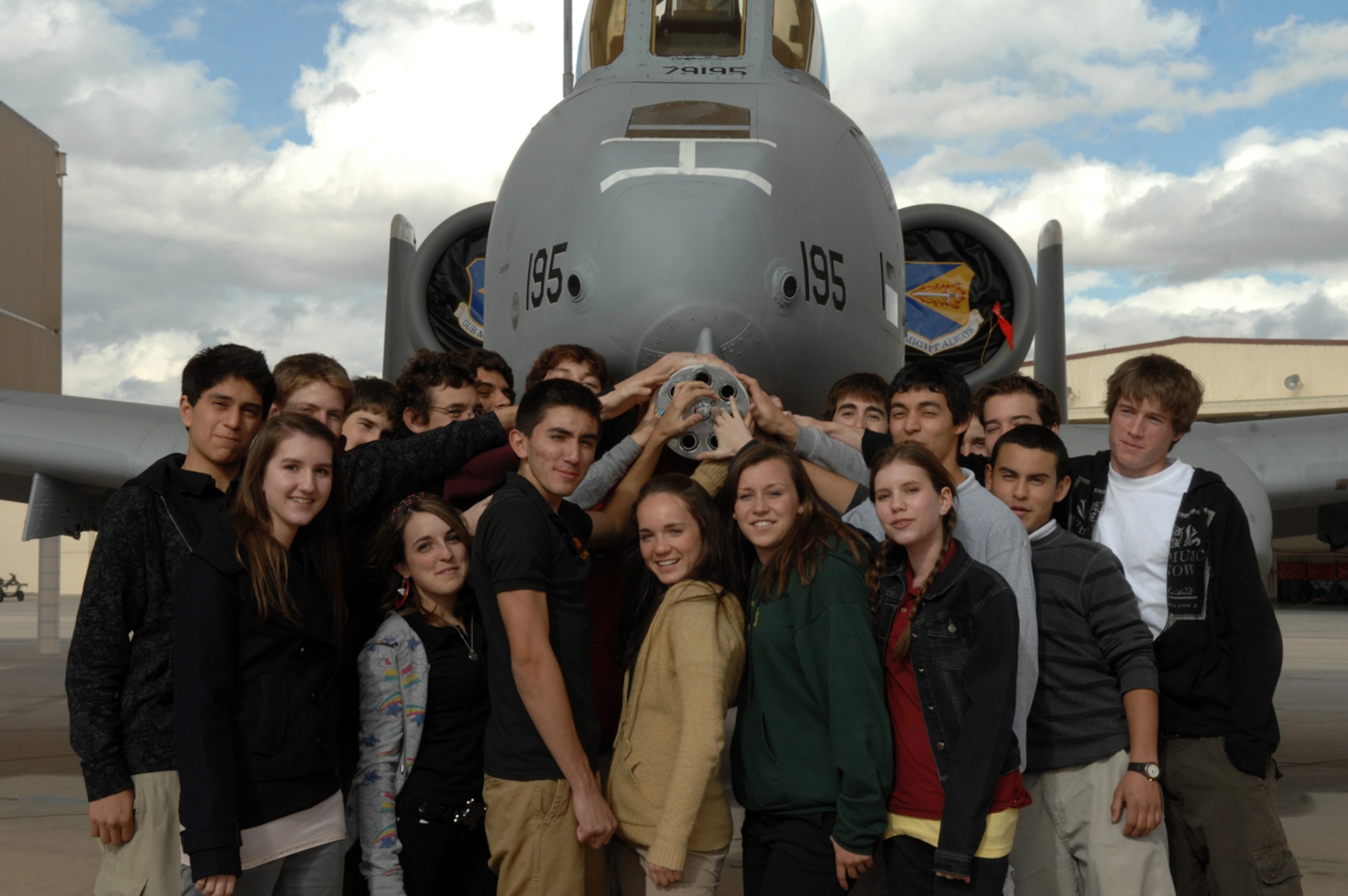 Members of Salpointe Catholic High School’s “American Appreciation Club” pose in front of an A-10 Thunderbolt II aircraft on the flight line here Jan. 24. In November 2007, the patriotic club volunteered their time to support the Tee It Up for the Troops charity golf event and raised funds for the Wounded Warrior Project, which prompted 355th Fighter Wing Commander Col. Kent Laughbaum to invite the group to Davis-Monthan for a tour. The students also saw several other aircraft on the flight line and toured the 309th Aerospace Maintenance and Regeneration Group here. (U.S. Air Force photo/Airman 1st Class Noah Johnson)