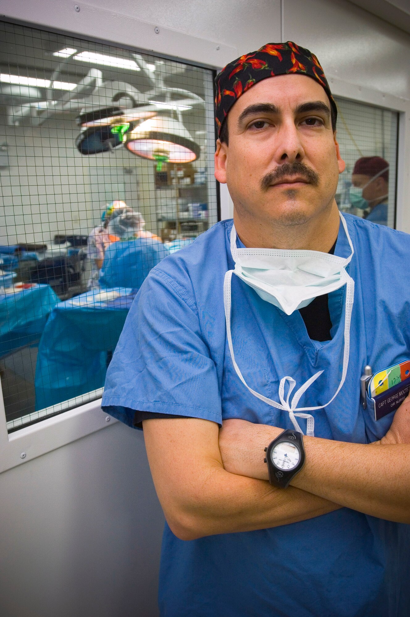 Capt. George Moctezuma, an operating room nurse, prepares to scrub a wounded patient before a surgical procedure at the Air Force Theater Hospital here. Captain Moctezuma received his degree in nursing as an enlisted medic and worked as a civilian nurse in his off-duty time before earning his commission. He is deployed from Wilford Hall Medical Center, San Antonio, Texas. (U.S. Air Force photo/Tech. Sgt. D. Clare) 
