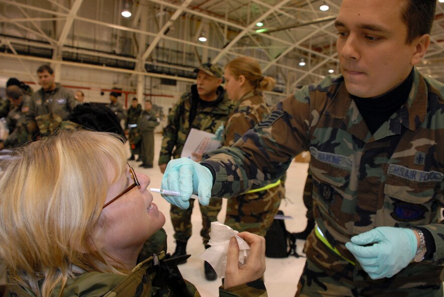 Tech. Sgt. Christopher Barone, 914th Aeromedical Staging Squadron, administers the flu mist vaccine to Master Sgt. Ruth Verbanic, 914th Airlift Wing.  The annual flu "shot" has been replaced by the flu "mist" for the majority of today's Air Force reservists.  (U.S. Air Force photo/Master Sgt. Peter Borys)