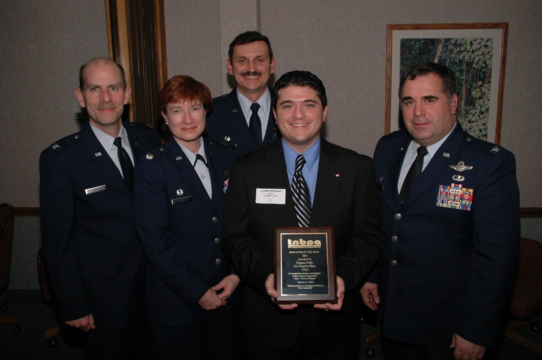 NIAGARA FALLS ARS, N.Y. - Chief operating officer of local business "Opportunities Unlimited", Peter Drew, stands with 914th Airlift Wing command staff after presenting the wing the "Employer of the Year" award from The Town of Niagara Business and Professional Associates (TNBPA).  Wing staff pictured with Mr. Drew are (left to right) Col. Kurt Hammer, Mission Support Group commander, Col. Sharon Johnson, Maintenance Group commander, Col. Reinhard Schmidt, wing commander, Col. Terry Lawrence, Operations Group commander.  (U.S. Air Force photo/Airman Andrew Caya)