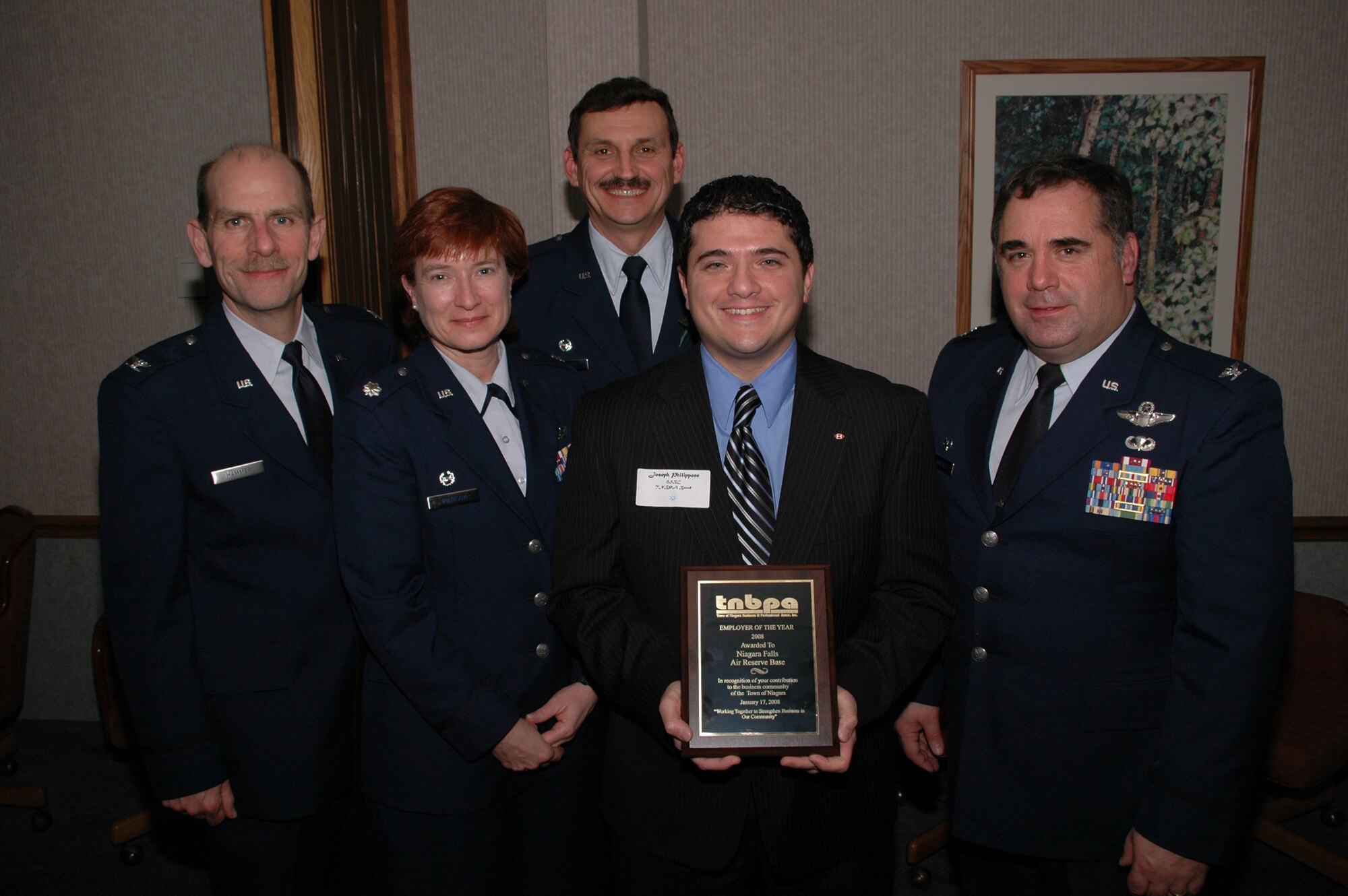 NIAGARA FALLS ARS, N.Y. - Chief operating officer of local business "Opportunities Unlimited", Peter Drew, stands with 914th Airlift Wing command staff after presenting the wing the "Employer of the Year" award from The Town of Niagara Business and Professional Associates (TNBPA).  Wing staff pictured with Mr. Drew are (left to right) Col. Kurt Hammer, Mission Support Group commander, Col. Sharon Johnson, Maintenance Group commander, Col. Reinhard Schmidt, wing commander, Col. Terry Lawrence, Operations Group commander.  (U.S. Air Force photo/Airman Andrew Caya)
