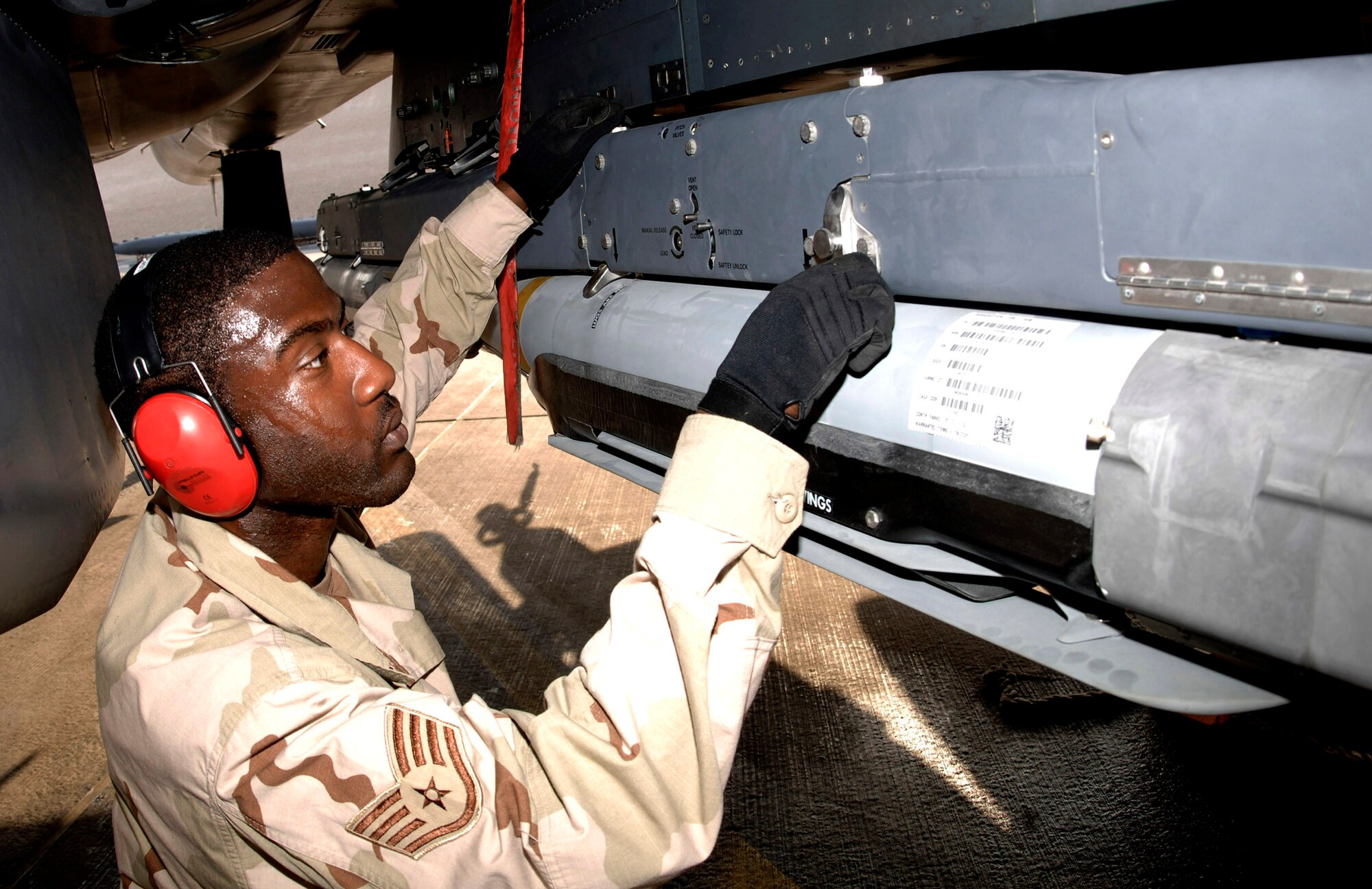 Staff Sgt. Kevin Harvey of the 379th Expeditionary Aircraft Maintenance Squadron secures GBU-39/B small diameter bombs to an F-15E Strike Eagle in the Southwest Asia area of operations.  The bombs? smaller warheads allow U.S. commanders to destroy targets close to friendly troops, civilians, structures and personal property.  They represent one way in which airpower technology is helping the United States fight insurgencies, according to Maj. Gen. Charles J. Dunlap Jr., author of a new Air University monograph on counterinsurgency doctrine. (U.S. Air Force photo/Senior Airman Ricky Best) 
